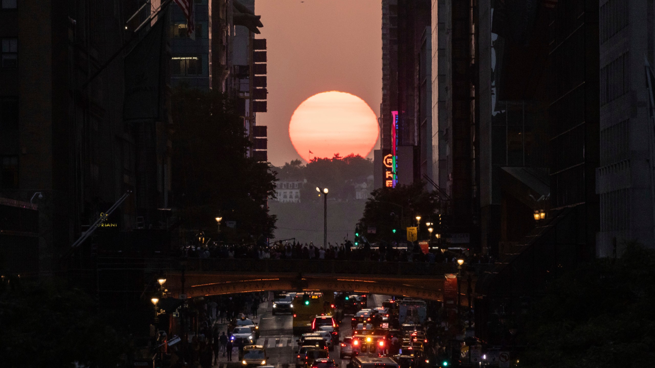 FILE - The sun sets as seen between buildings along 42nd Street in New York, May 30, 2023. (AP Photo/Yuki Iwamura, file)