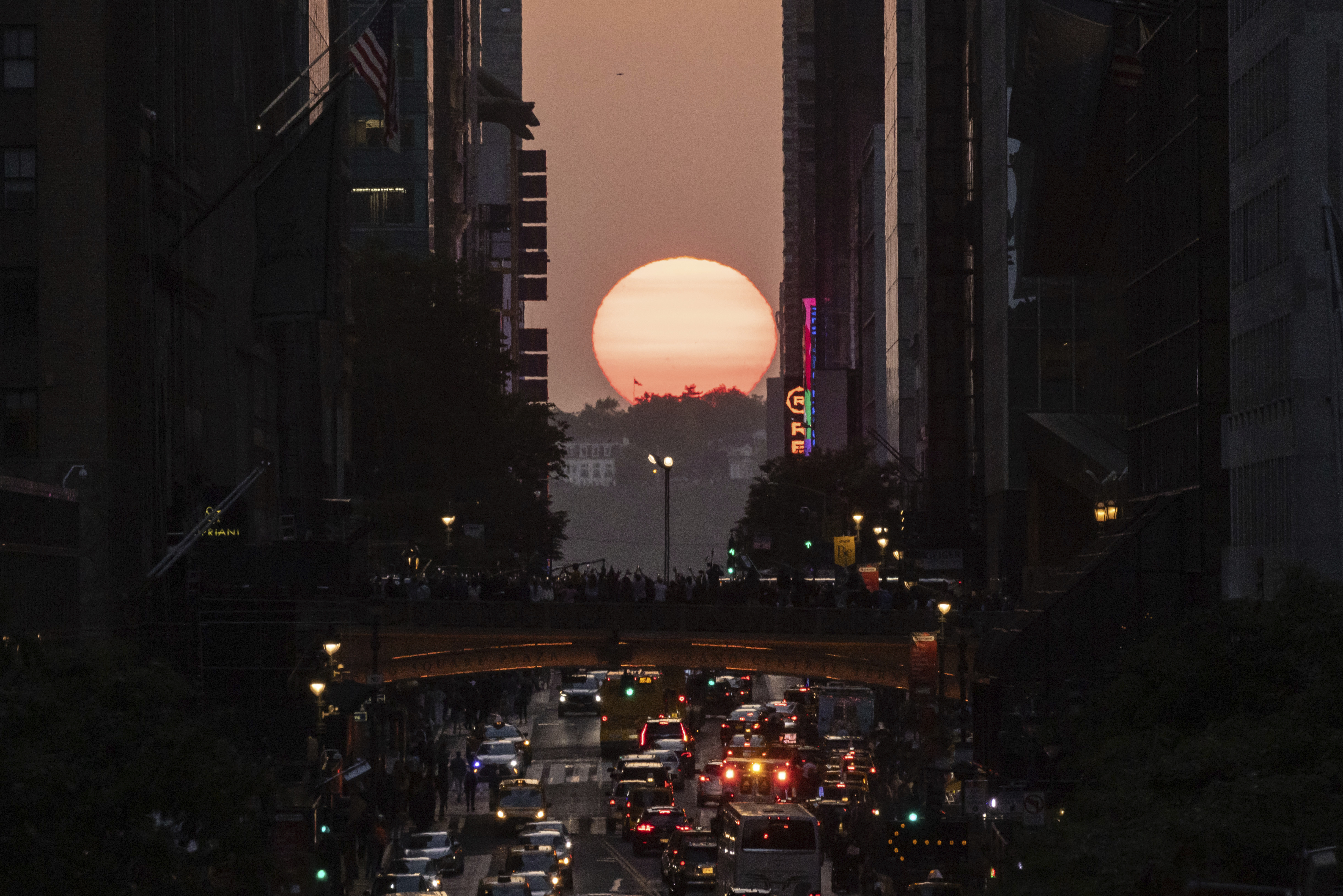 FILE - The sun sets as seen between buildings along 42nd Street in New York, May 30, 2023. (AP Photo/Yuki Iwamura, file)
