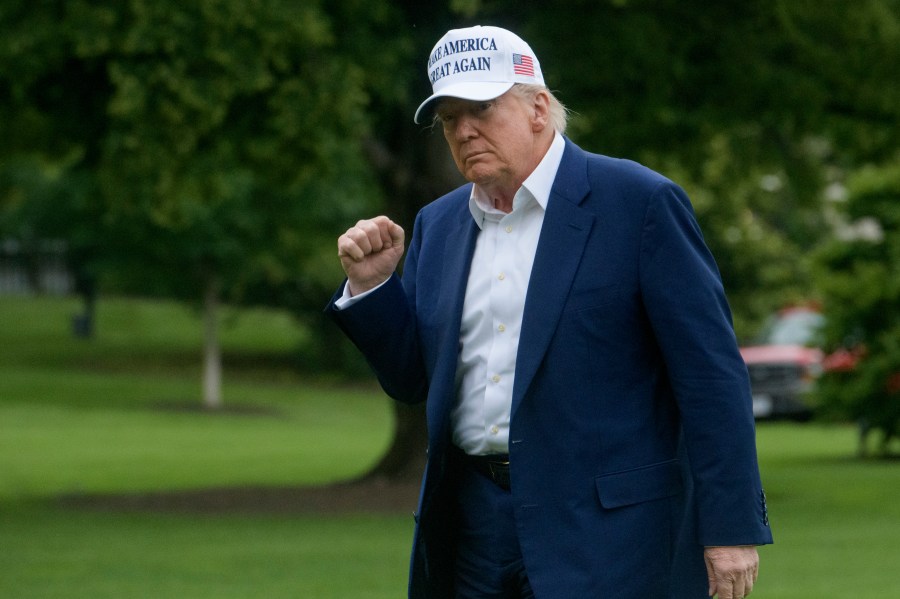 President Donald Trump acknowledges reporters as he disembarks Marine One upon arrival on the South Lawn of the White House in Washington, Sunday, May 25, 2025. (AP Photo/Rod Lamkey, Jr.)