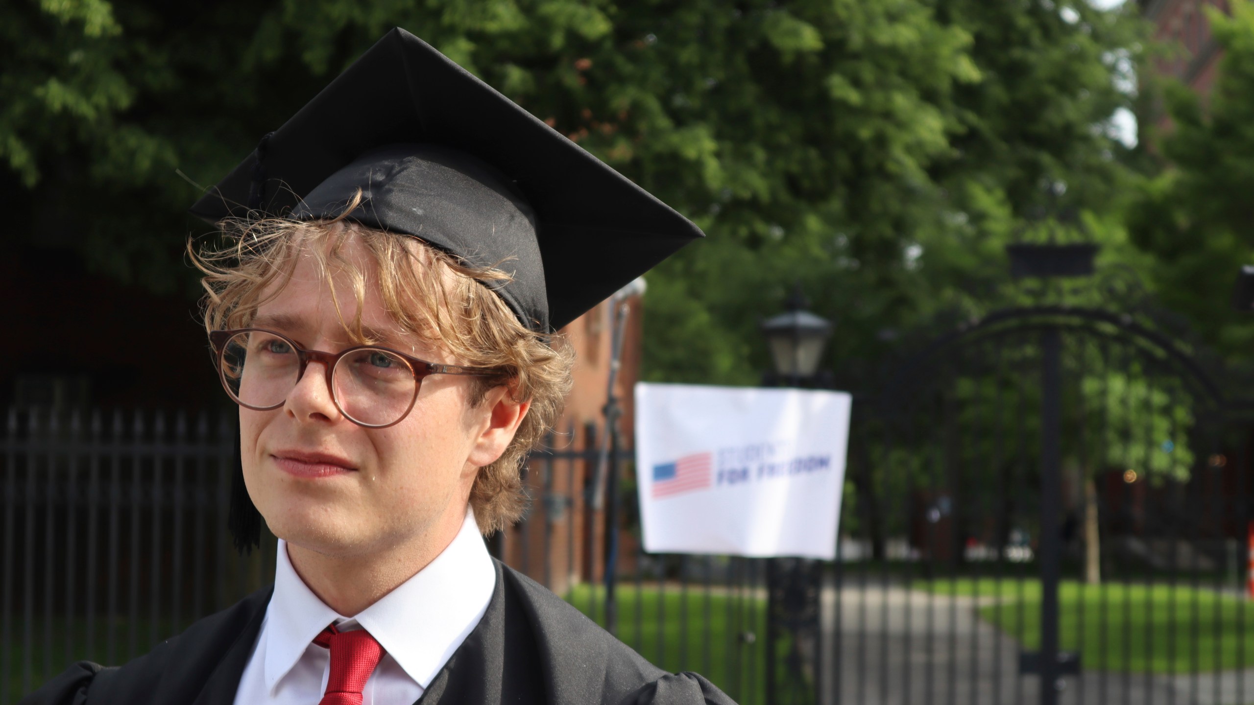 Harvard University graduating senior Leo Gerdén, an international student from Sweden, stands outside the Harvard University gates before a student protest against President Donald Trump's recent sanctions against Harvard, Tuesday May 27, 2025, in Cambridge, Mass. (AP Photo/Leah Willingham)