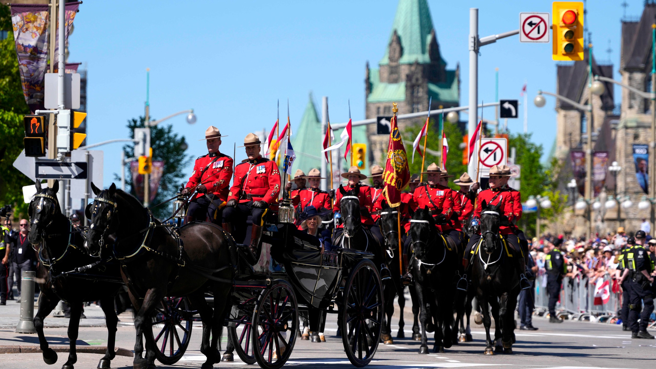 King Charles and Queen Camilla arrive by horse-drawn landau at the Senate of Canada building in Ottawa, Canada, during a royal visit on Tuesday, May 27, 2025. (Justin Tang/The Canadian Press via AP)