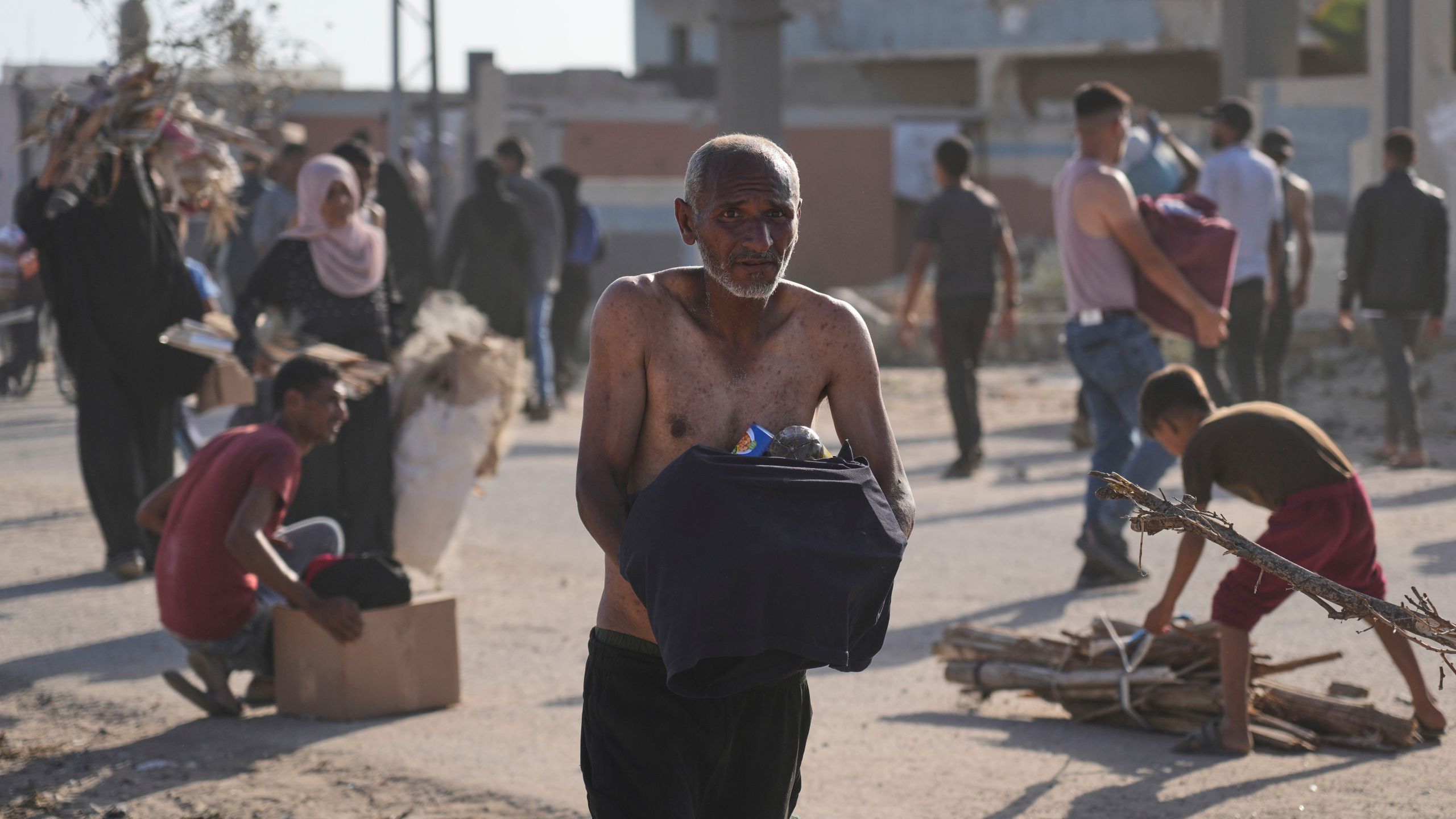 Palestinians carry boxes containing food and humanitarian aid packages delivered by the Gaza Humanitarian Foundation, a U.S.-backed organization approved by Israel, in Rafah, southern Gaza Strip, on Tuesday, May 27, 2025. (AP Photo/Abdel Kareem Hana)