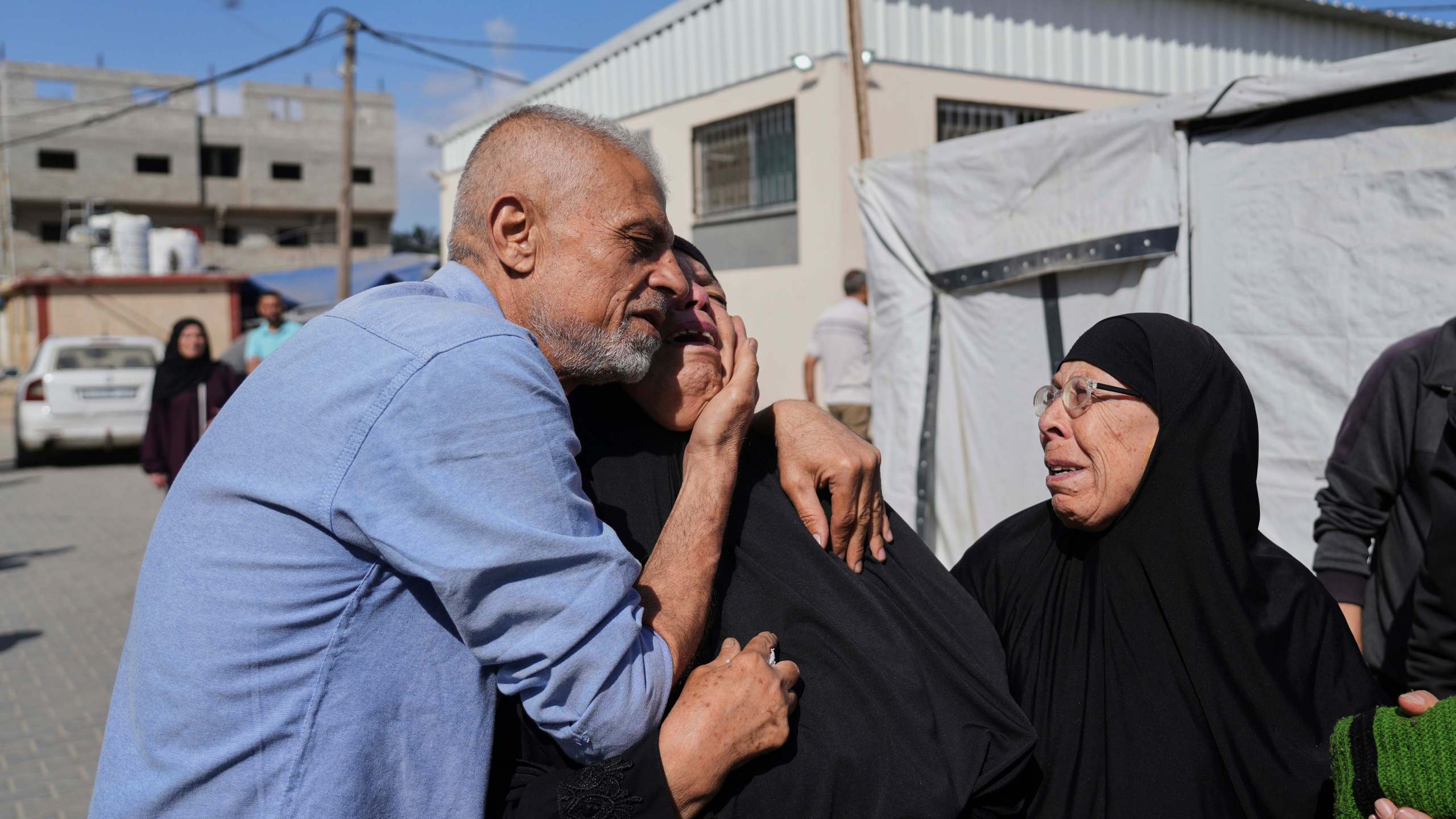 Palestinians mourn during the funeral of their relatives who were killed in an Israeli army airstrike on the Gaza Strip, at the Al-Aqsa Hospital in Deir al-Balah, Gaza, Wednesday, May 28, 2025. (AP Photo/Abdel Kareem Hana)