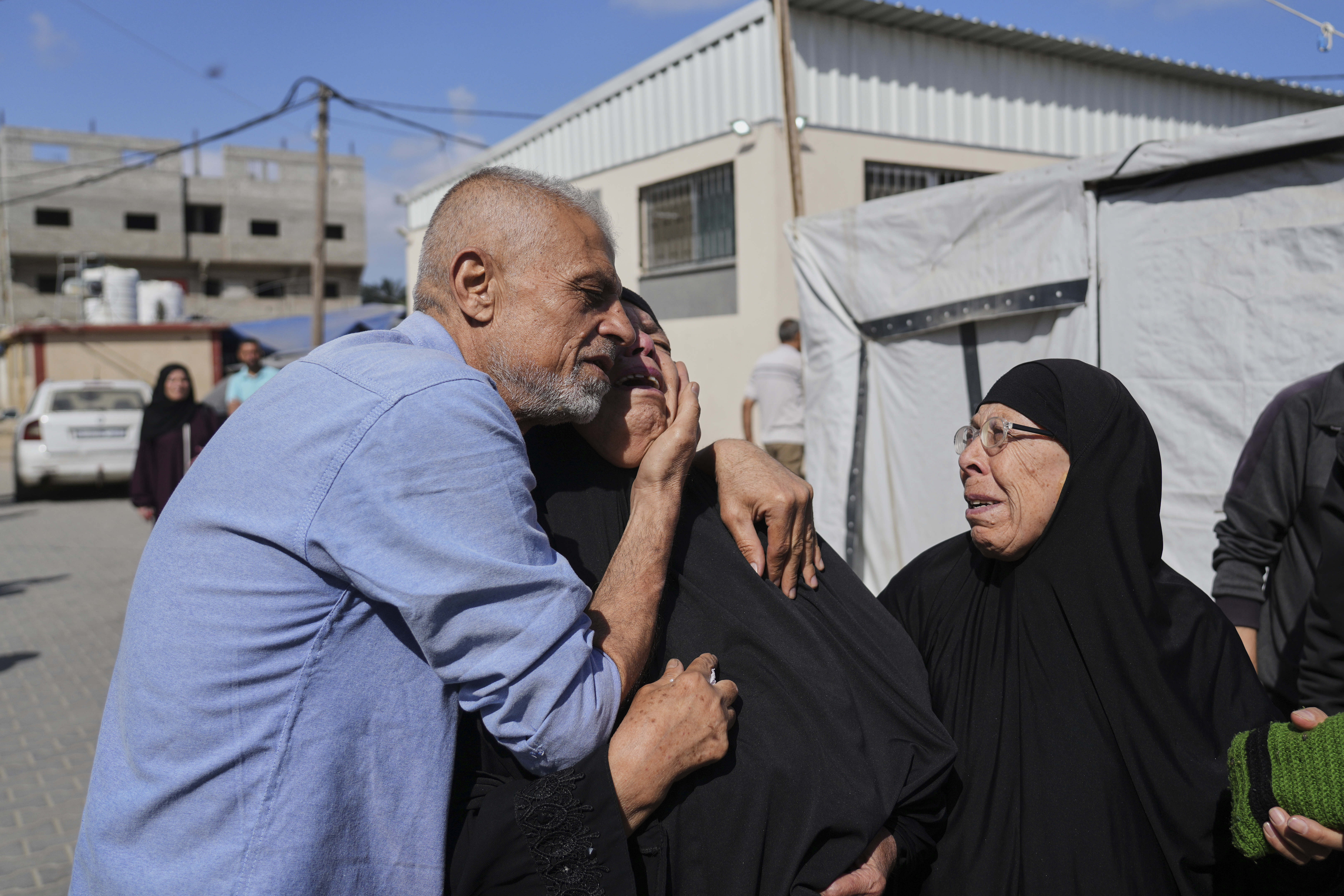 Palestinians mourn during the funeral of their relatives who were killed in an Israeli army airstrike on the Gaza Strip, at the Al-Aqsa Hospital in Deir al-Balah, Gaza, Wednesday, May 28, 2025. (AP Photo/Abdel Kareem Hana)