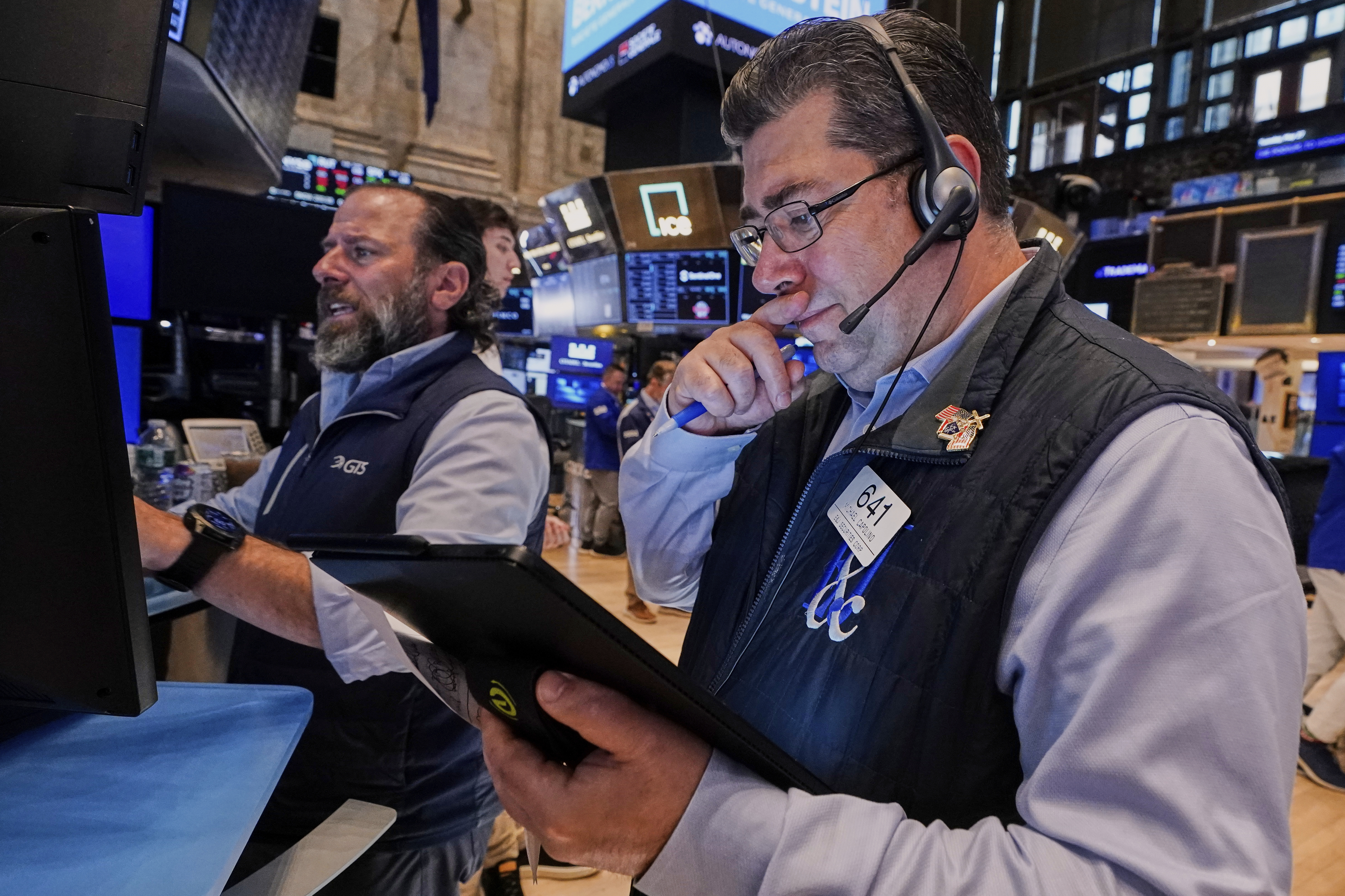 Specialist Michael Pistillo, left, and trader Michael Capolino work on the floor of the New York Stock Exchange, Tuesday, May 27, 2025. (AP Photo/Richard Drew)