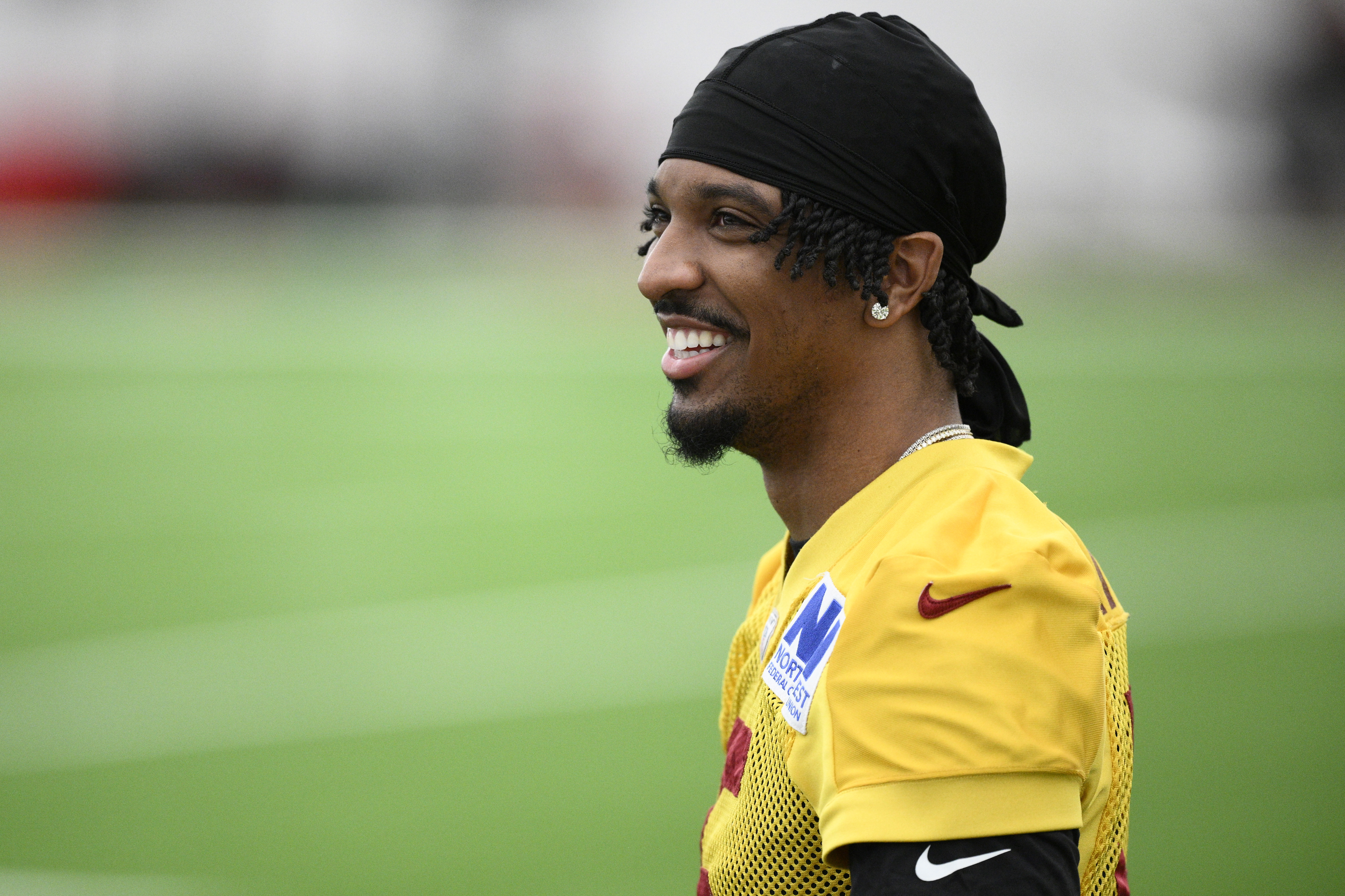 Washington Commanders quarterback Jayden Daniels looks on during an NFL football practice, Wednesday, May 28, 2025, in Ashburn, Va. (AP Photo/Nick Wass)