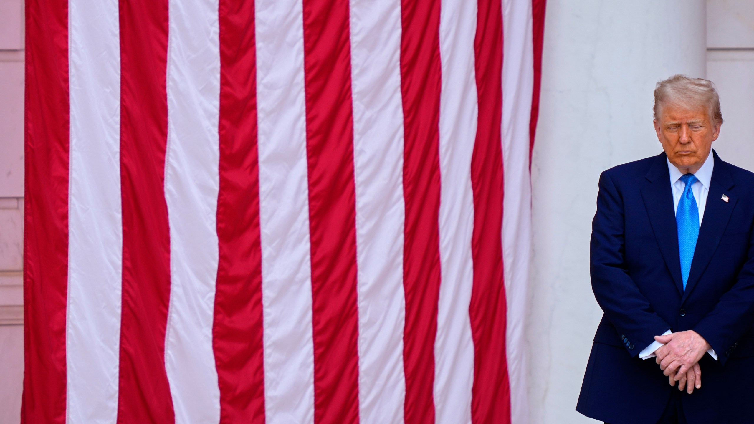 President Donald Trump bows his head in prayer with others, before delivering the Memorial Day Address at the 157th National Memorial Day Observance at Arlington National Cemetery, Monday, May 26, 2025, in Arlington, Va. (AP Photo/Julia Demaree Nikhinson)