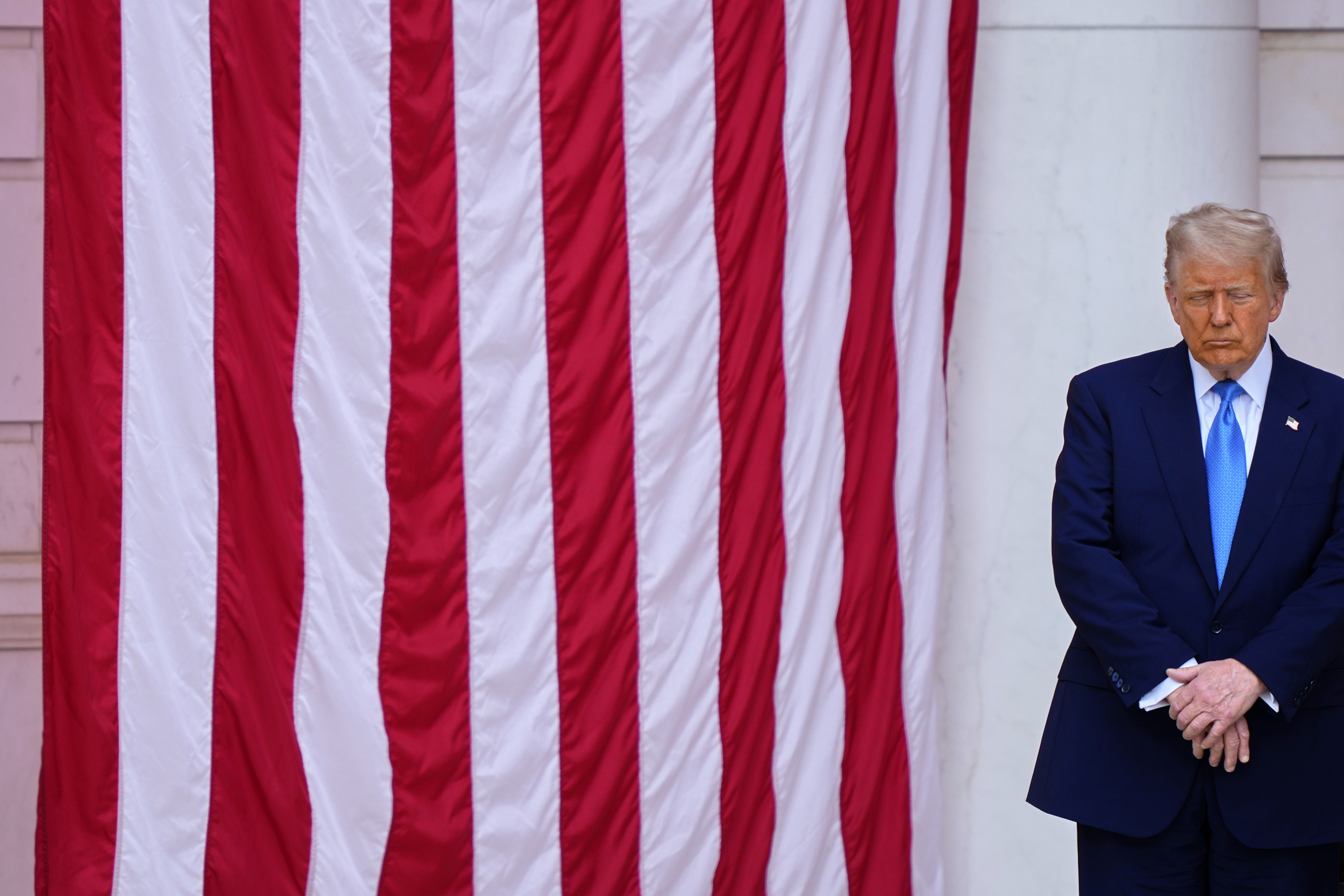 President Donald Trump bows his head in prayer with others, before delivering the Memorial Day Address at the 157th National Memorial Day Observance at Arlington National Cemetery, Monday, May 26, 2025, in Arlington, Va. (AP Photo/Julia Demaree Nikhinson)