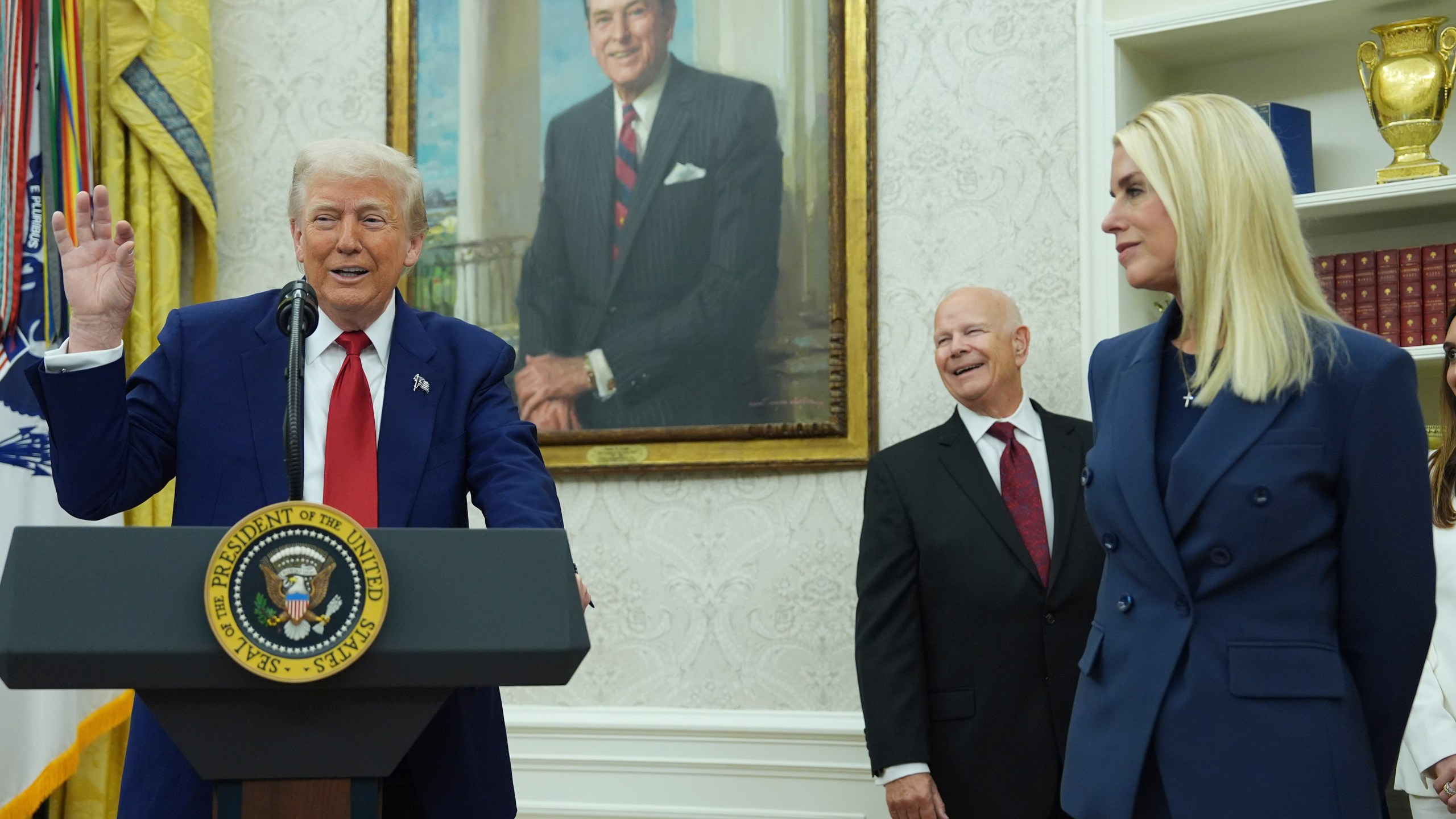 President Donald Trump, left, gestures as Attorney Genera, Pam Bondi, right, looks on during a swearing in ceremony for interim U.S. Attorney General for the District of Columbia Jeanine Pirro, Wednesday, May 28, 2025, in the Oval Office of the Whit House in Washington. (AP Photo/Evan Vucci)