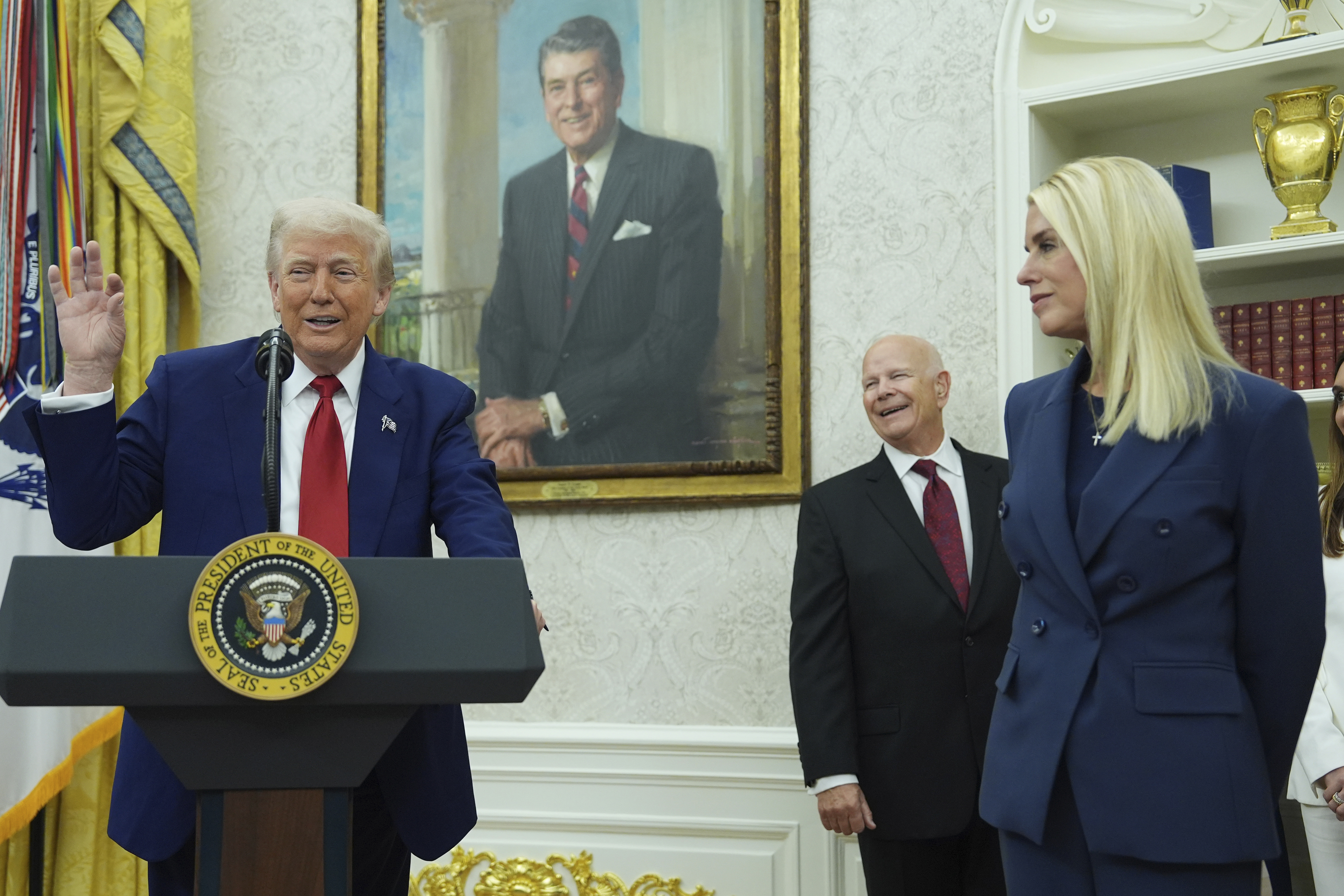 President Donald Trump, left, gestures as Attorney Genera, Pam Bondi, right, looks on during a swearing in ceremony for interim U.S. Attorney General for the District of Columbia Jeanine Pirro, Wednesday, May 28, 2025, in the Oval Office of the Whit House in Washington. (AP Photo/Evan Vucci)