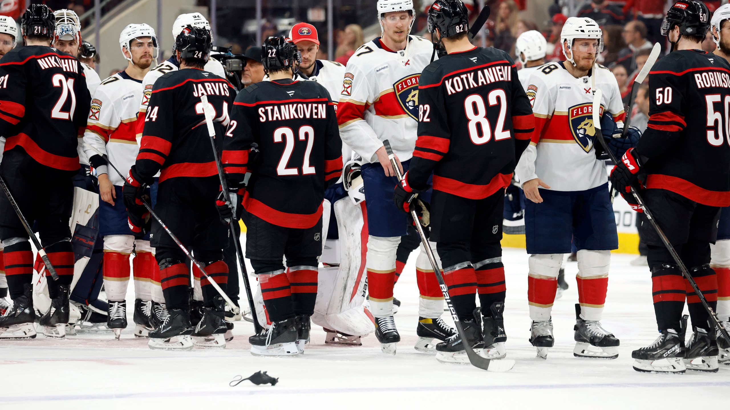 The Florida Panthers shake hands with the Carolina Hurricanes following Florida's win in Game 5 of the NHL hockey Stanley Cup Eastern Conference finals in Raleigh, N.C., Wednesday, May 28, 2025. (AP Photo/Karl DeBlaker)