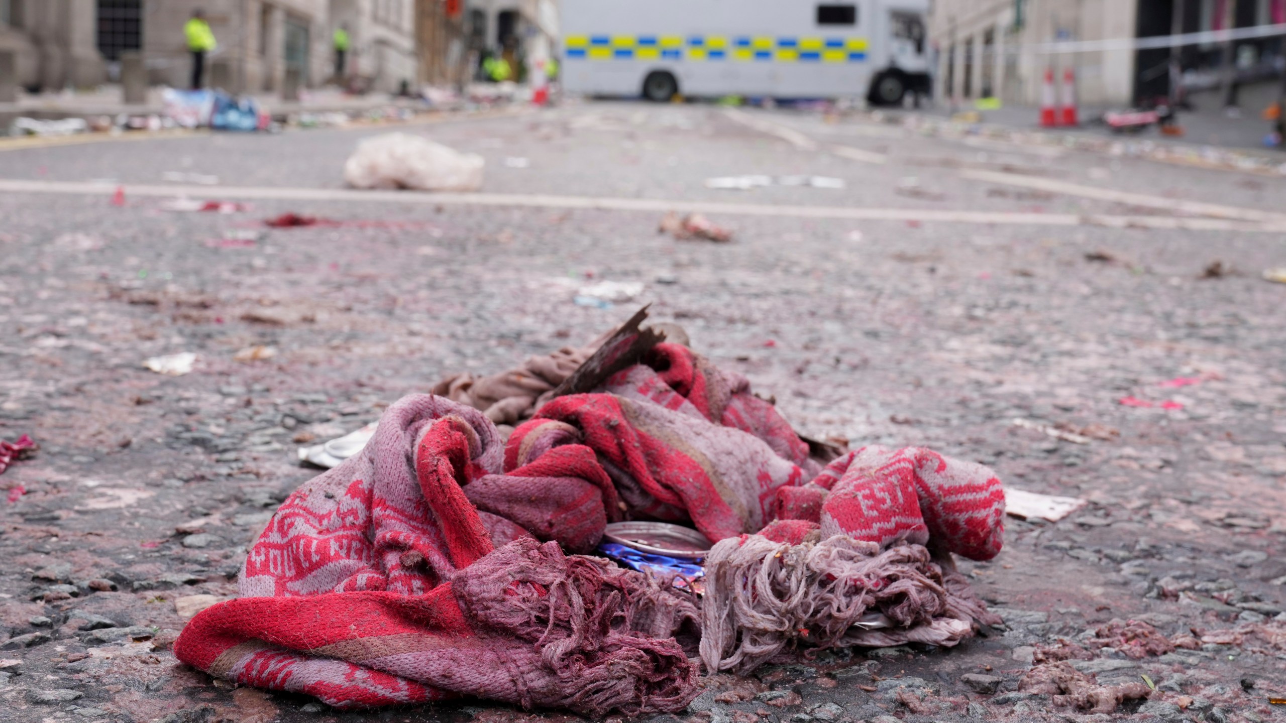 A fan scarf lies near the site where a 53-year-old British man plowed a minivan into a crowd of Liverpool soccer fans who were celebrating the city's Premier League championship Monday, injuring more than 45 people in Liverpool, England, Tuesday, May 27, 2025.(AP Photo/Jon Super)