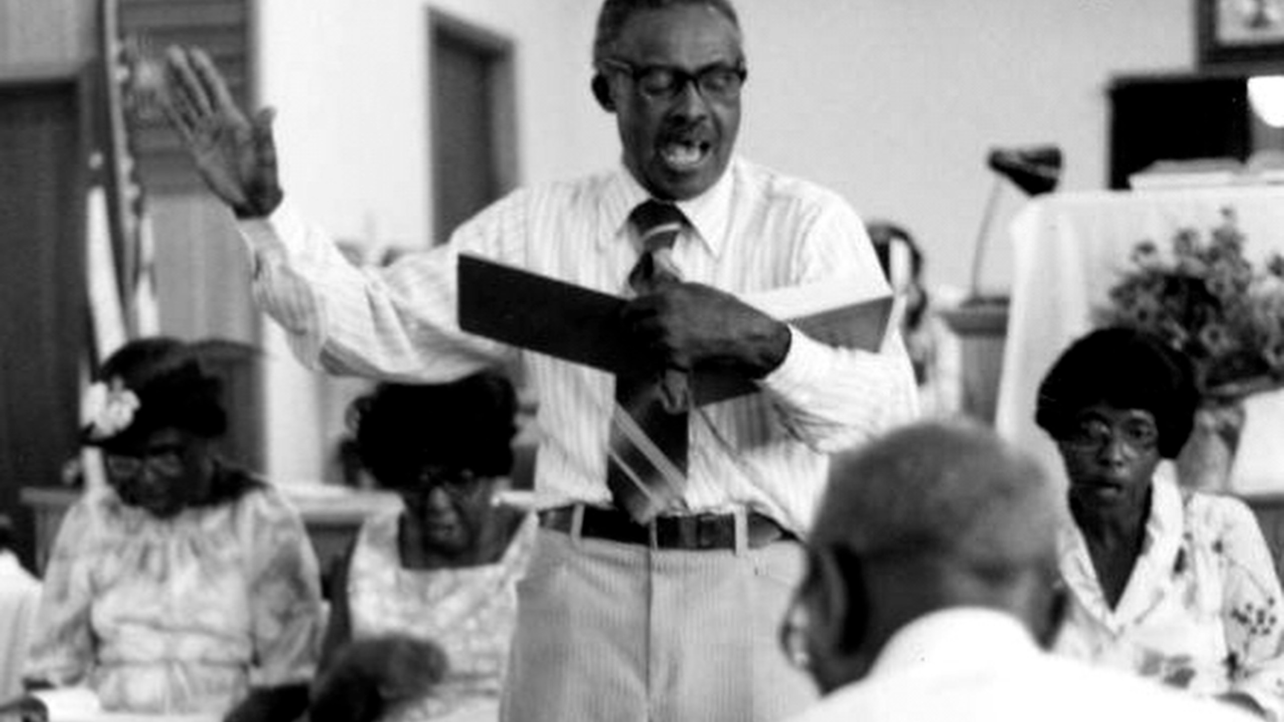 In this photo provided by the State Archives of Florida, M.L. Long leads sacred harp singers at the S.E. Alabama & Florida Union Sacred Harp Sing in Campbellton, Fla., on Nov. 24, 1980. (Peggy A. Bulger/State Archives of Florida via AP)