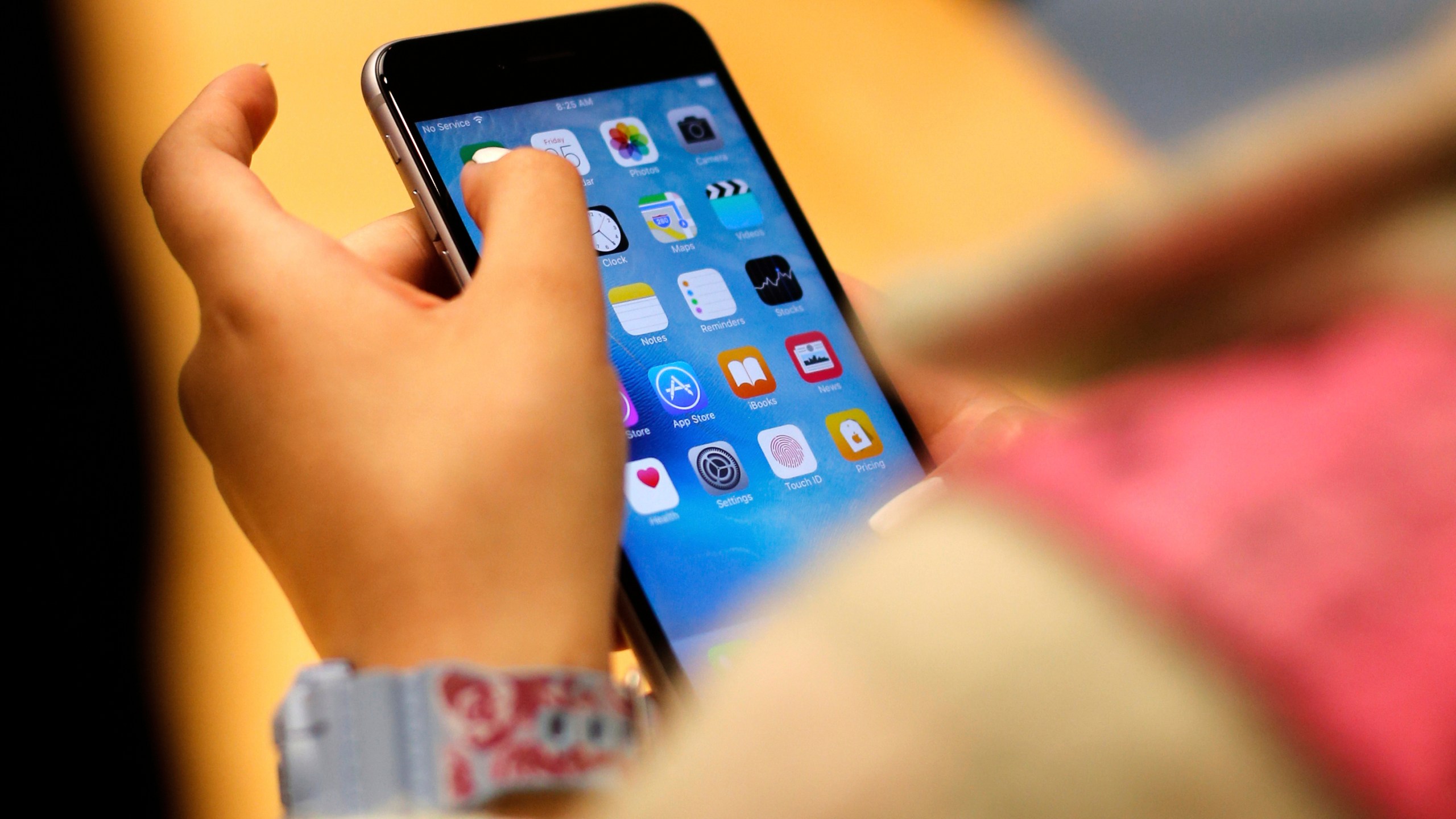 FILE - A child holds an iPhone at an Apple store on Sept. 25, 2015 in Chicago. (AP Photo/Kiichiro Sato, File)