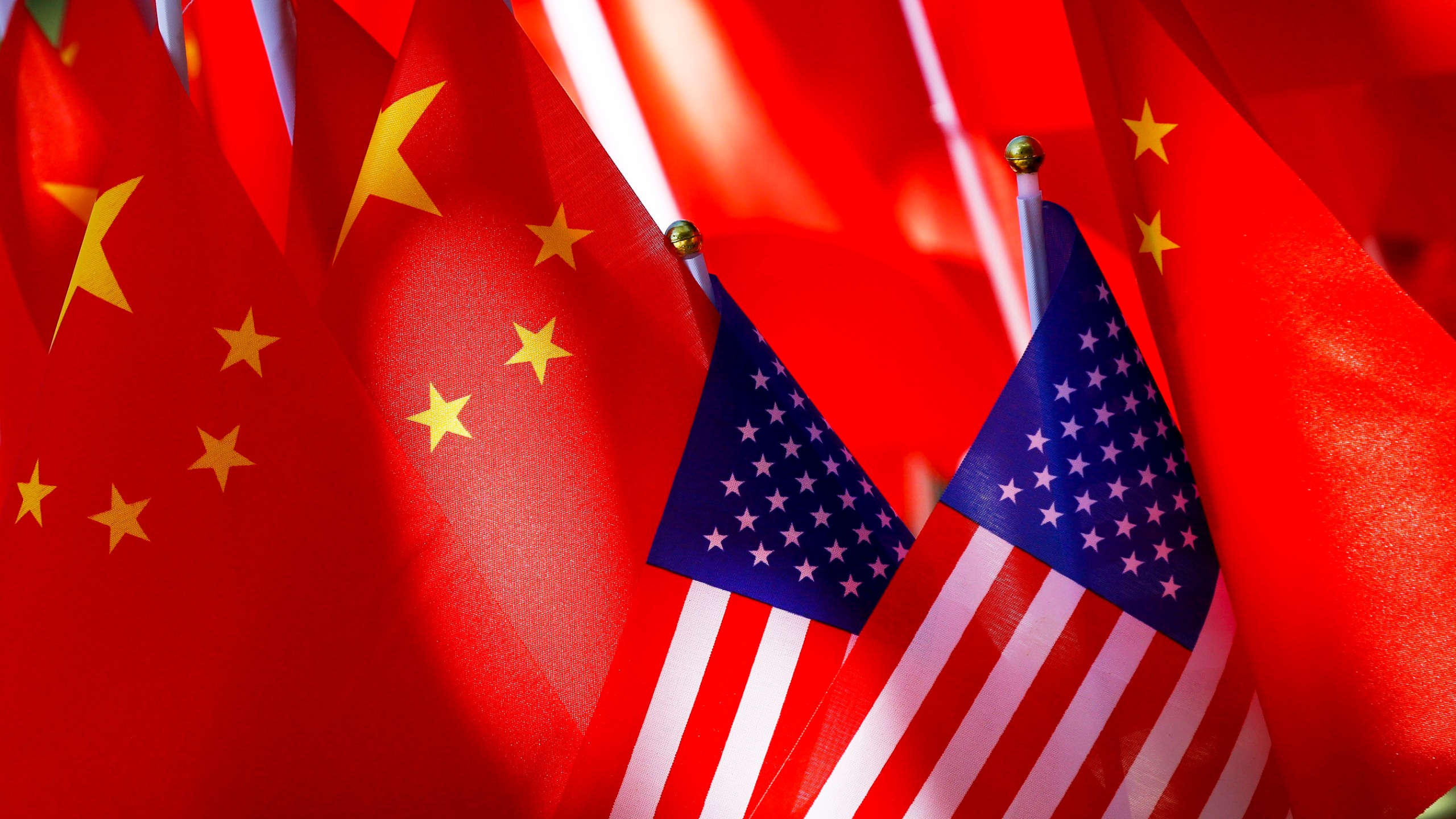 FILE - American flags are displayed together with Chinese flags on top of a trishaw on Sept. 16, 2018, in Beijing. (AP Photo/Andy Wong, File)