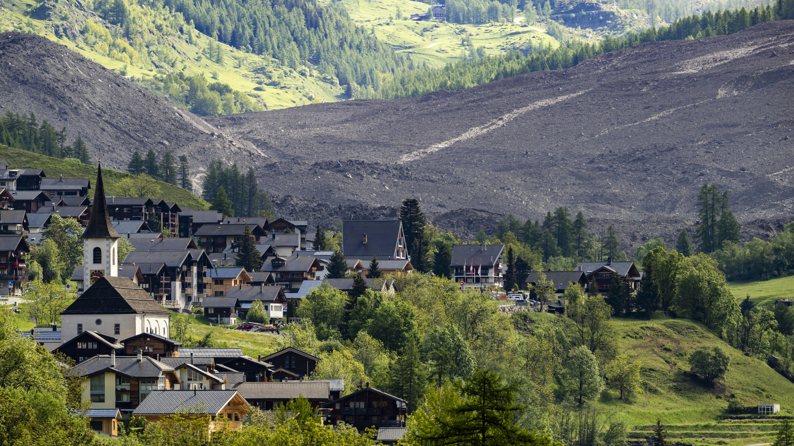 A massive debris avalanche, with the village of Kippel in the foreground, is seen on Thursday, May 29, 2025, one day after the collapse of the Birch Glacier causing the demolishing of the village of Blatten in Switzerland. (Jean-Christophe Bott/Keystone via AP)