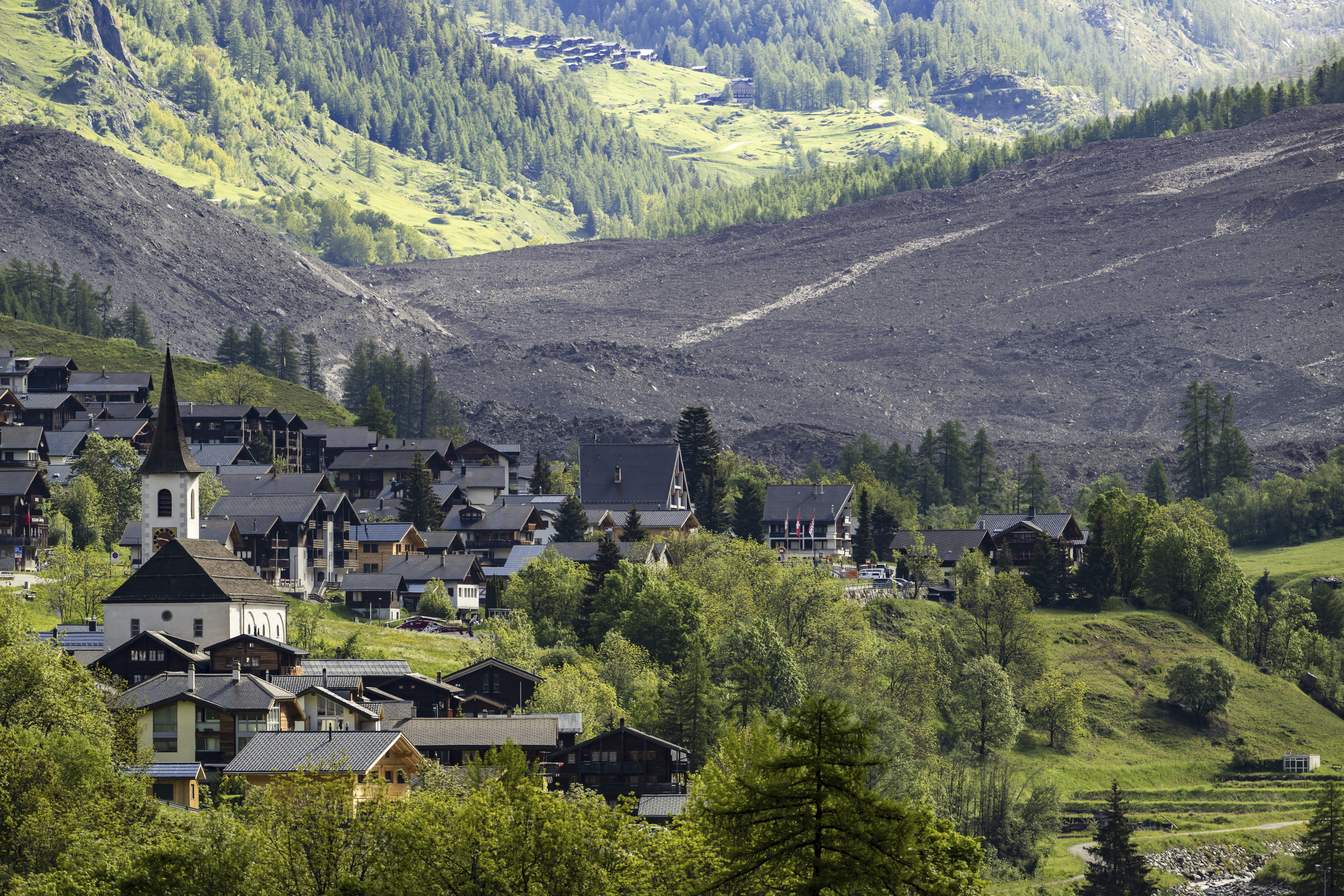 A massive debris avalanche, with the village of Kippel in the foreground, is seen on Thursday, May 29, 2025, one day after the collapse of the Birch Glacier causing the demolishing of the village of Blatten in Switzerland. (Jean-Christophe Bott/Keystone via AP)