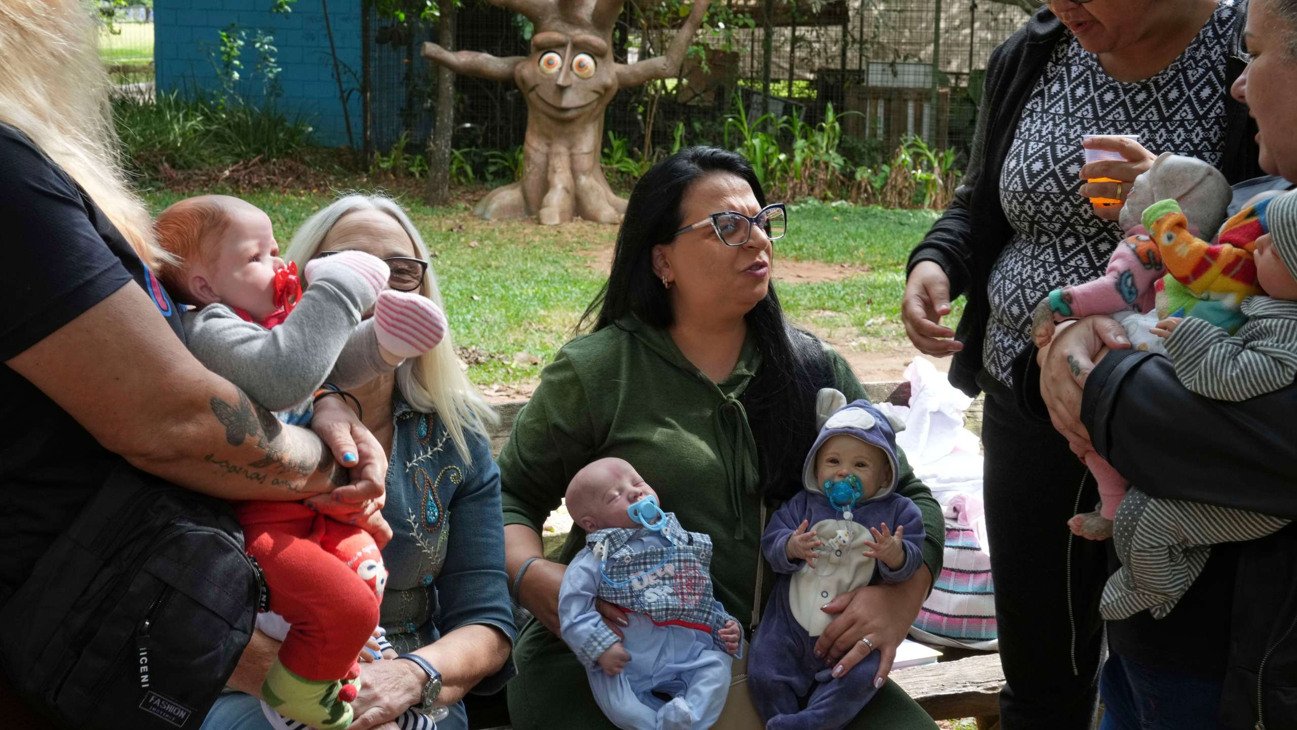 A group of women gather in a park to bond and show off their hyper-realistic reborn baby dolls, in Sao Paulo, Saturday, May 24, 2025. (AP Photo/Andre Penner)
