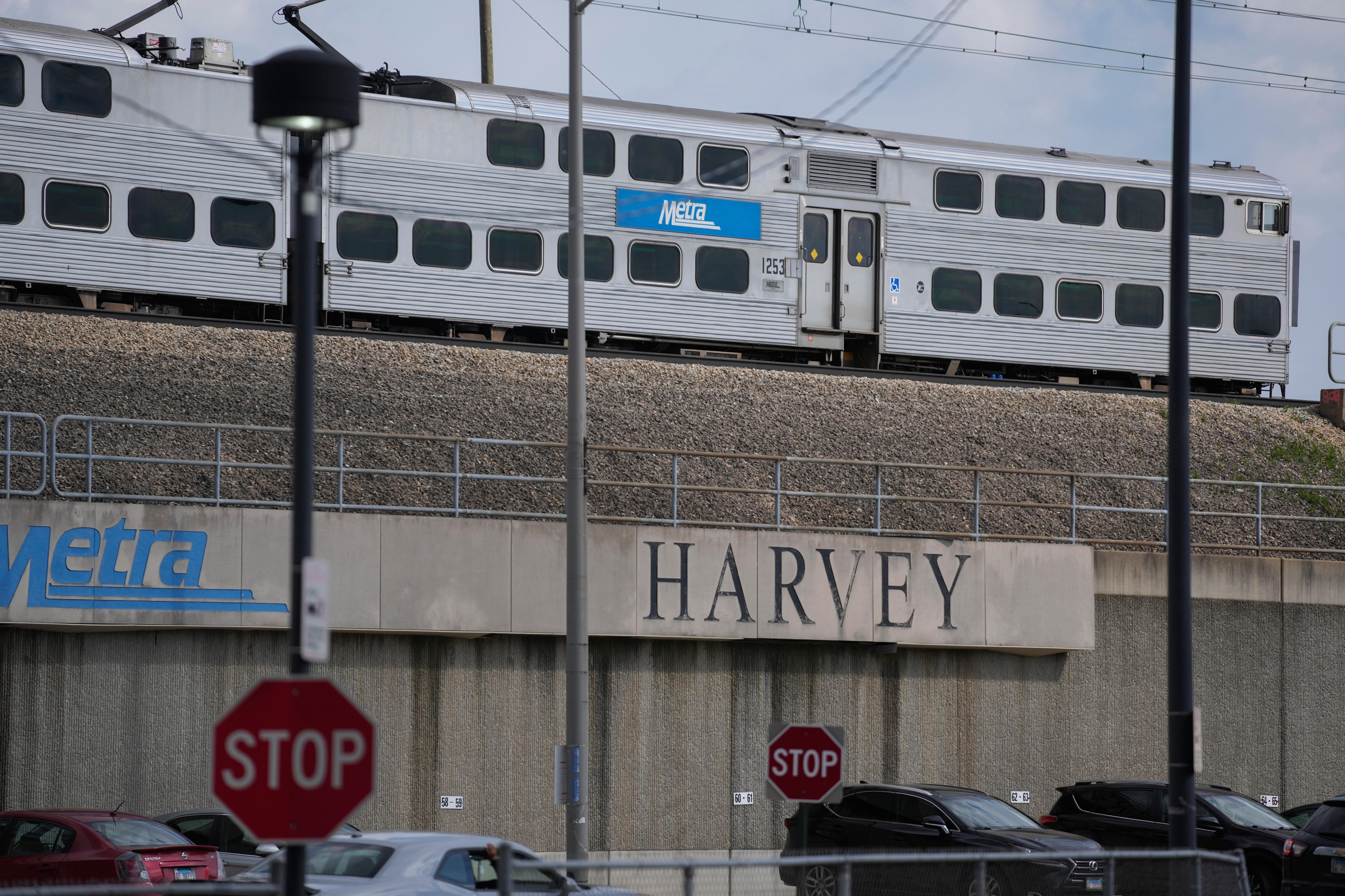 A Metra train leaves the station across from the Pace Harvey Transportation Center, Thursday, May 29, 2025, in Harvey, Ill. (AP Photo/Erin Hooley)