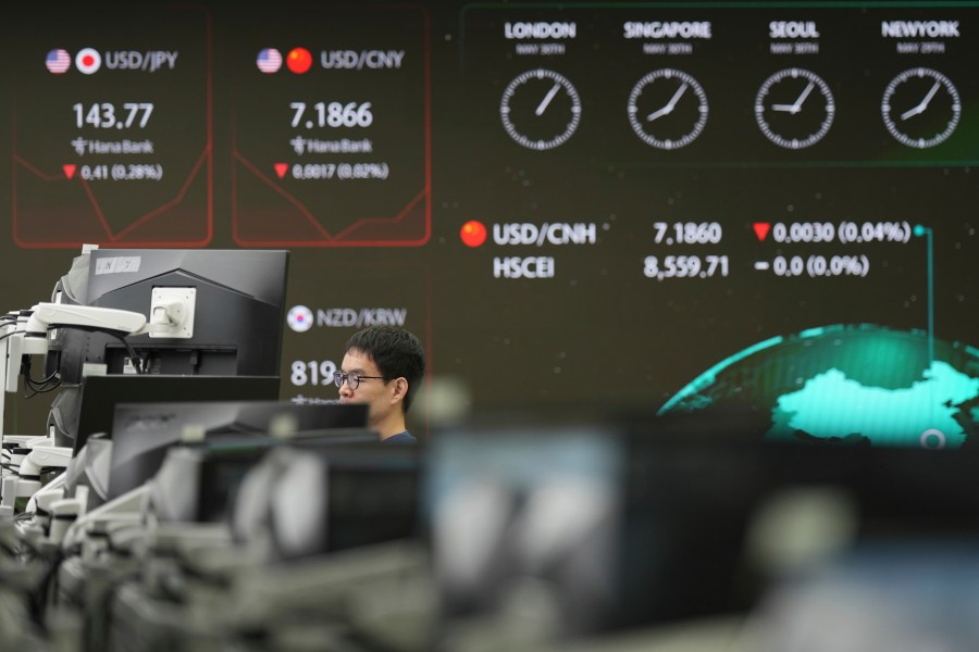 A dealer watches computer monitors near the screens showing the foreign exchange rates at a dealing room of Hana Bank in Seoul, South Korea, Friday, May 30, 2025. (AP Photo/Lee Jin-man)