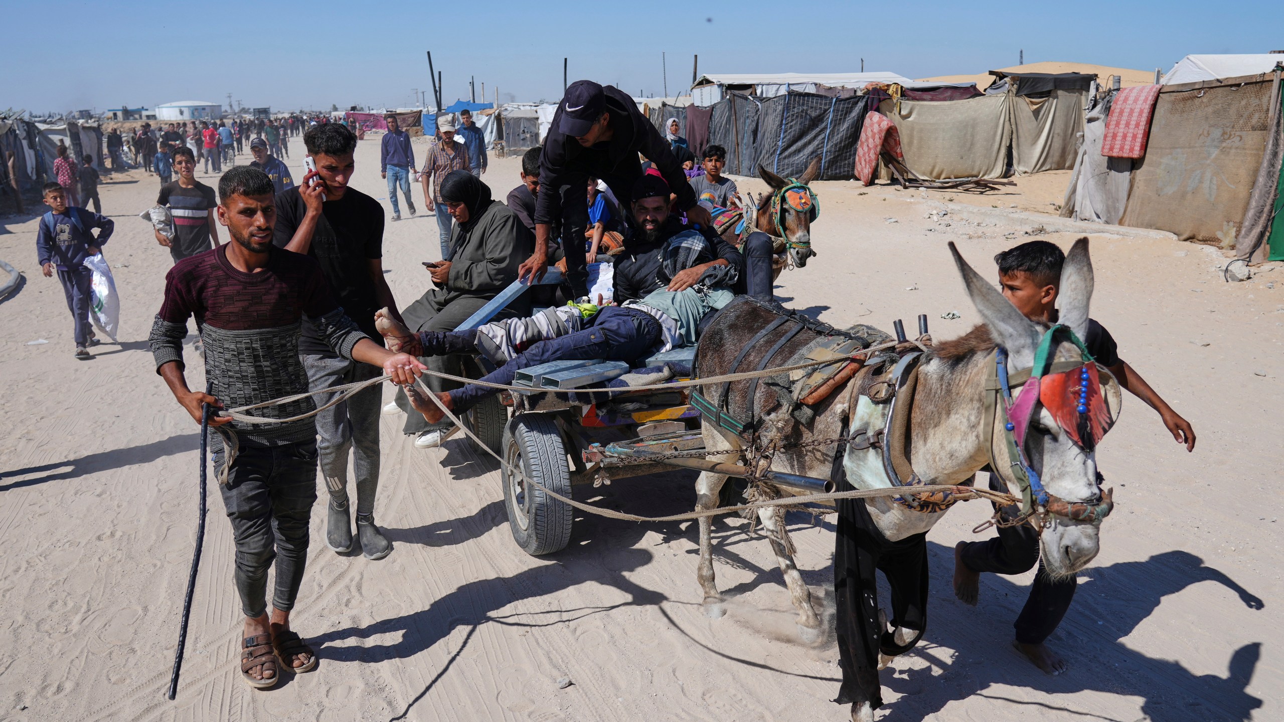 Palestinians carry an injured man after he was shot at an aid distribution center run by the Gaza Humanitarian Foundation a U.S.-backed organization approved by Israel in Khan Younis, southern Gaza Strip, on Thursday, May 29, 2025. (AP Photo/Abdel Kareem Hana)