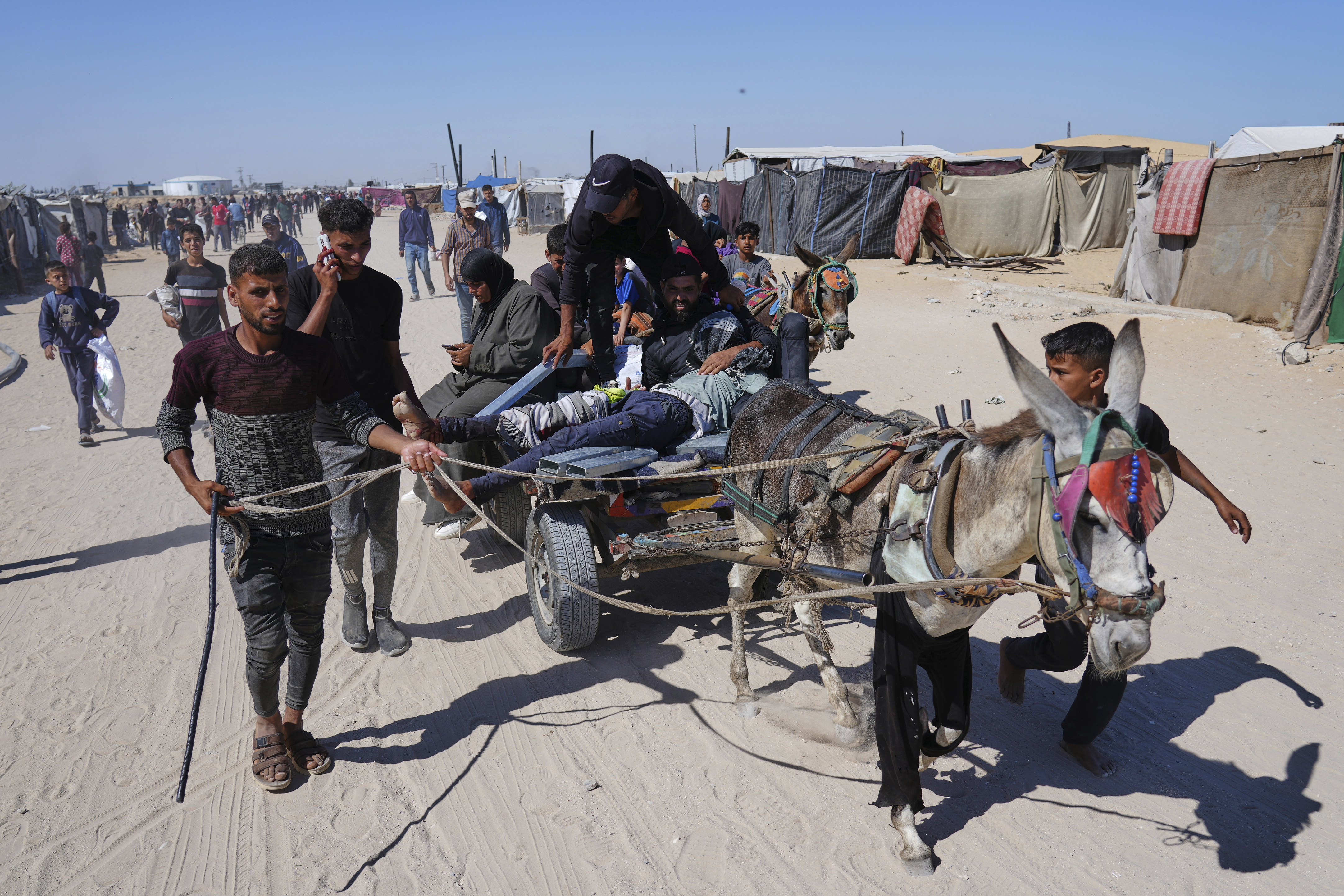 Palestinians carry an injured man after he was shot at an aid distribution center run by the Gaza Humanitarian Foundation a U.S.-backed organization approved by Israel in Khan Younis, southern Gaza Strip, on Thursday, May 29, 2025. (AP Photo/Abdel Kareem Hana)