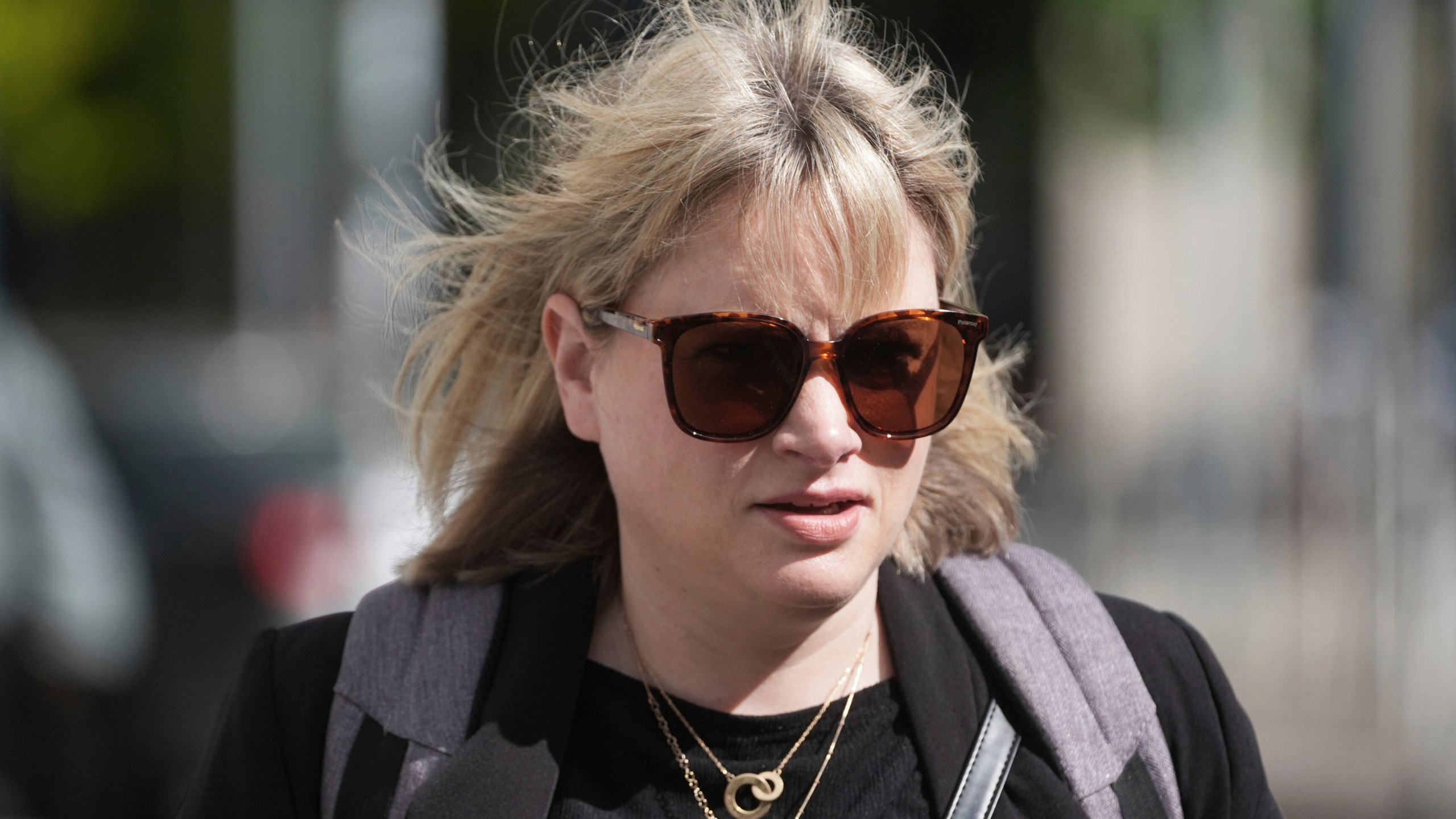 Producer Imelda Lynch walks outside the High Court where where former Sinn Fein president Gerry Adams is bringing a legal action against the BBC over allegations about the murder of an MI5 spy in 2006, in Dublin, Ireland, Wednesday May 28, 2025. (Brian Lawless/PA via AP)