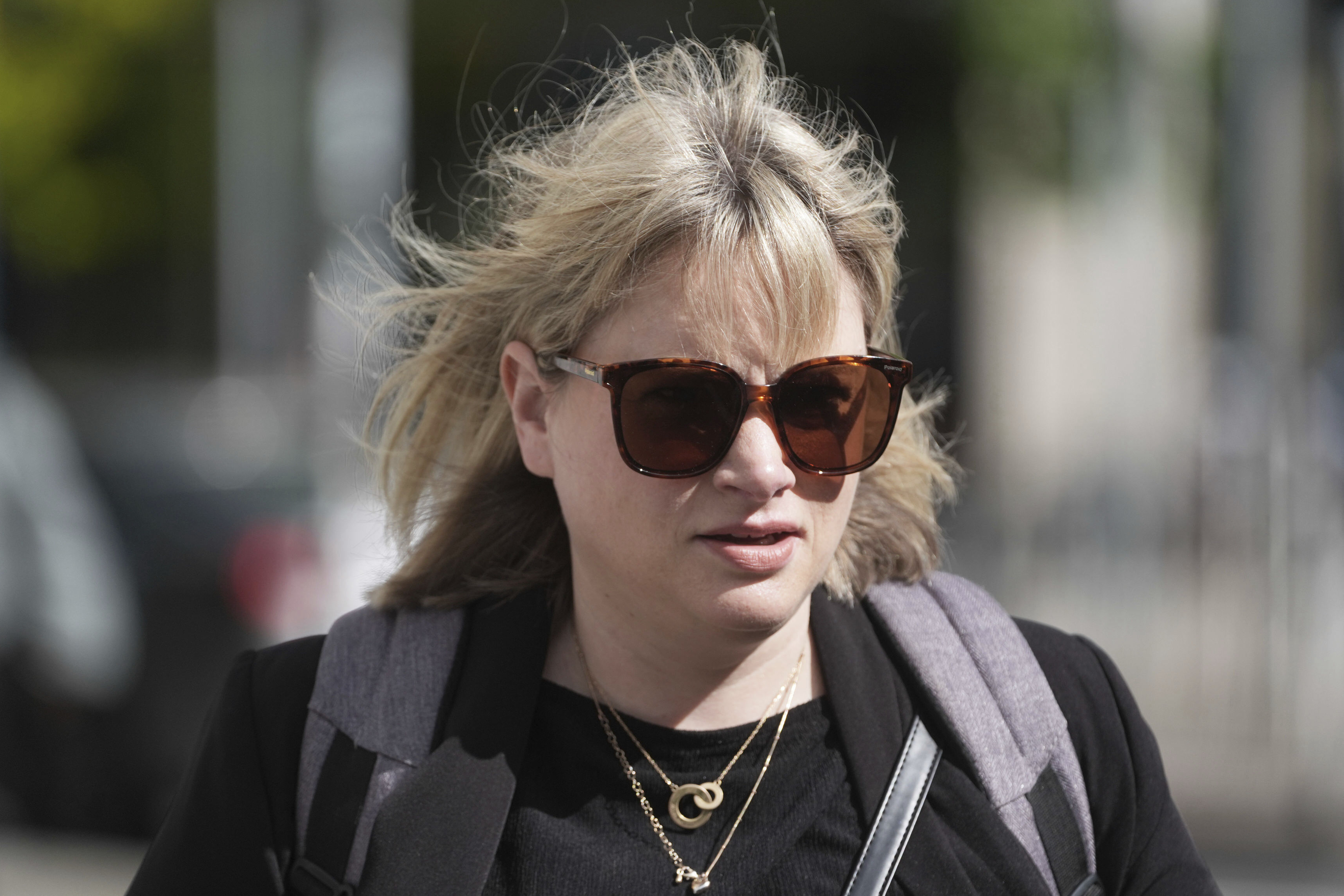 Producer Imelda Lynch walks outside the High Court where where former Sinn Fein president Gerry Adams is bringing a legal action against the BBC over allegations about the murder of an MI5 spy in 2006, in Dublin, Ireland, Wednesday May 28, 2025. (Brian Lawless/PA via AP)
