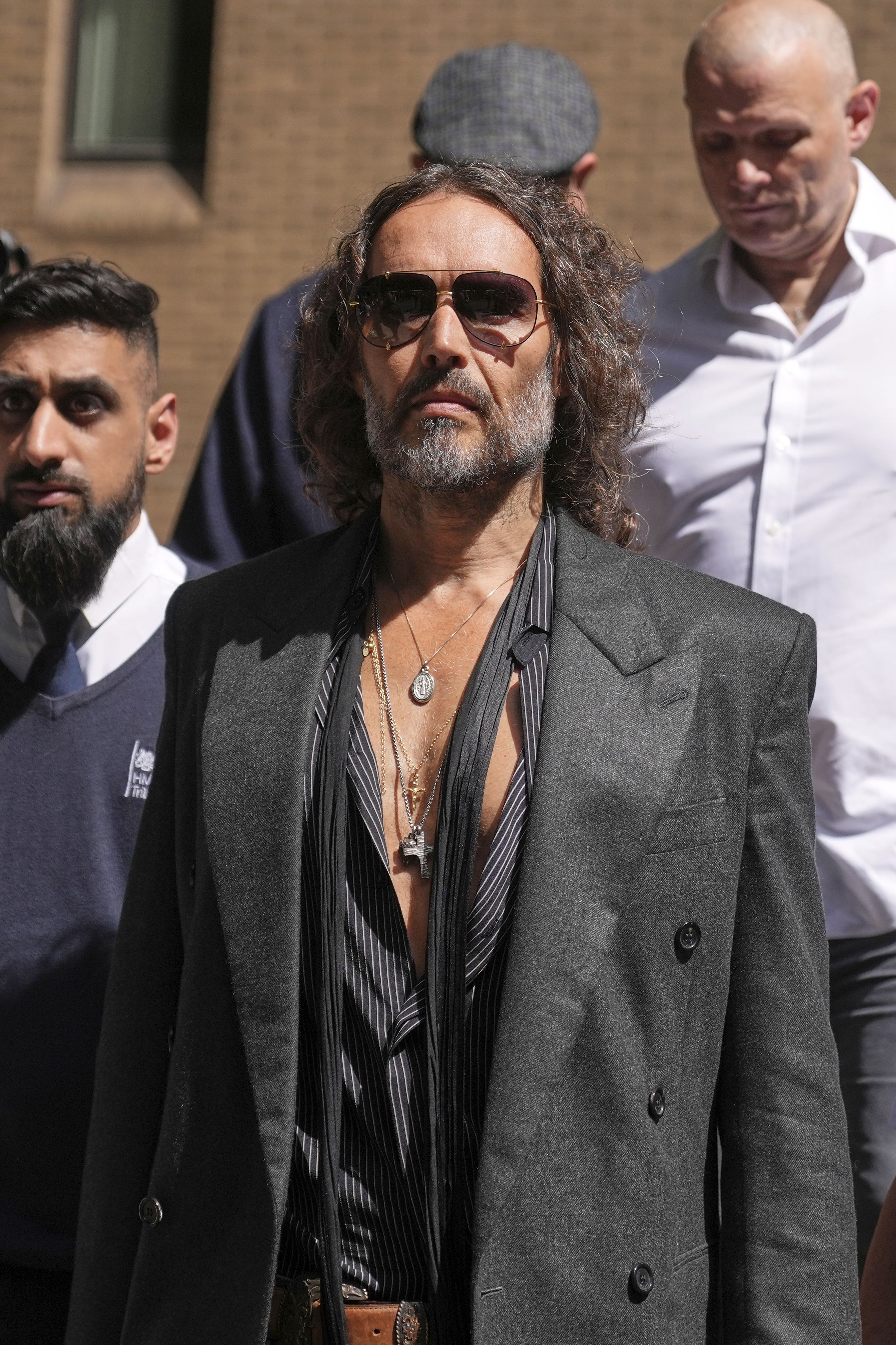 English comedian and actor Russell Brand leaves Southwark Crown Court where he is charged with rape and sexual assault in London, Friday, May 30, 2025.(AP Photo/Alastair Grant)