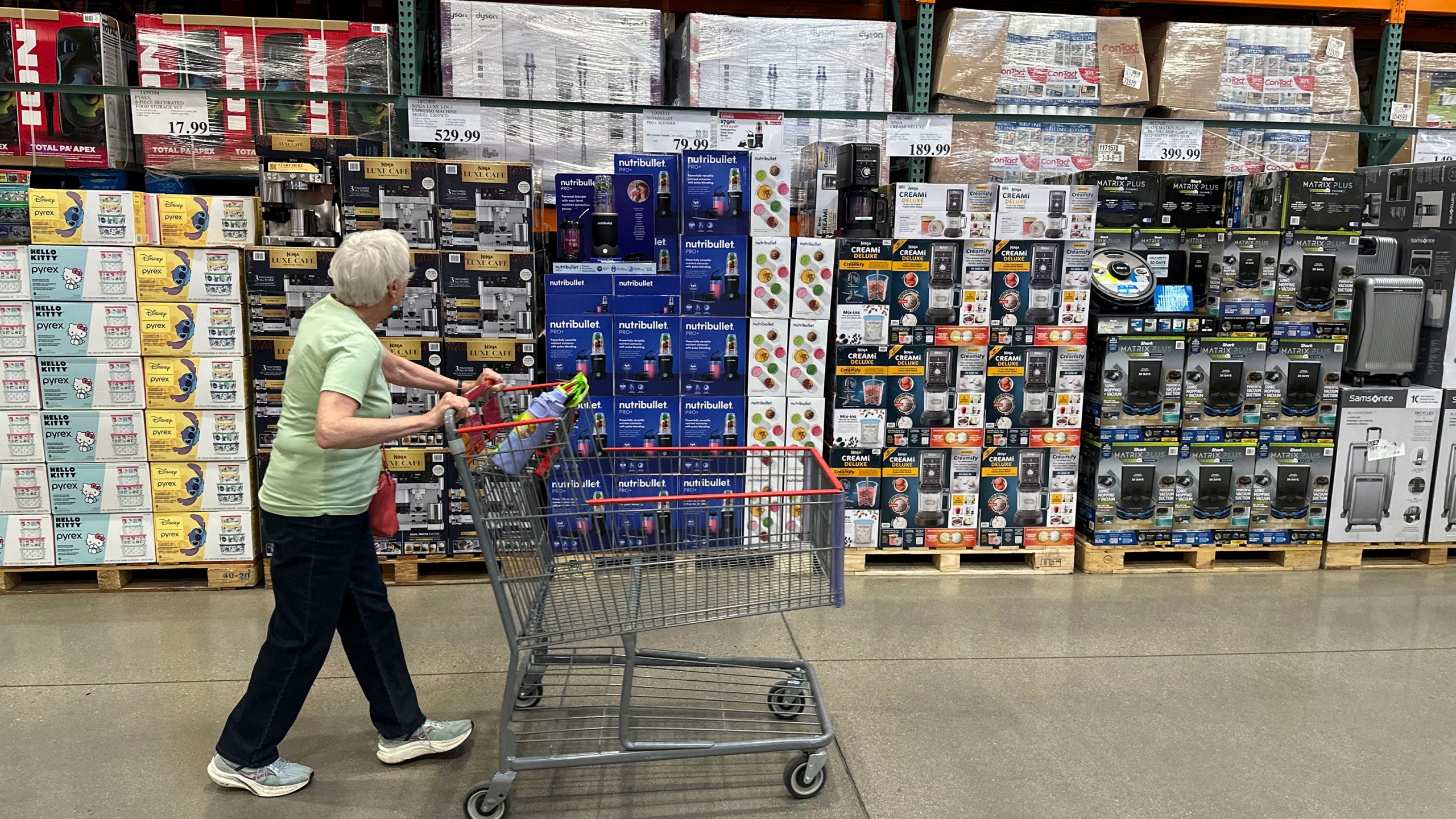 A shopper surveys goods on display in a Costco warehouse Wednesday, May 21, 2025, in Lone Tree, Colo. (AP Photo/David Zalubowski)