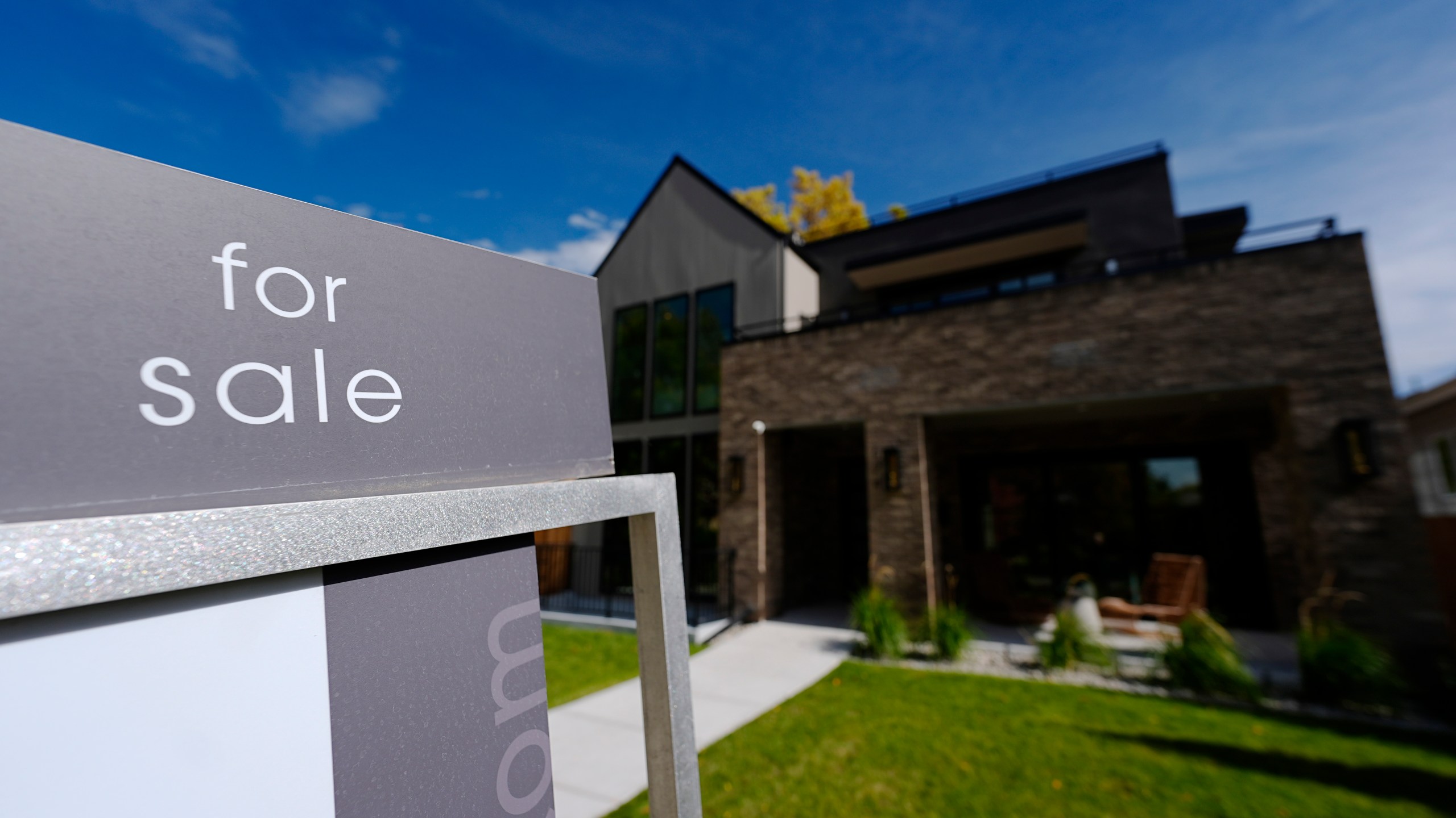 FILE - A sale sign stands outside a home on the market Thursday, Oct. 17, 2024, in the east Washington Park neighborhood of Denver. (AP Photo/David Zalubowski, File)
