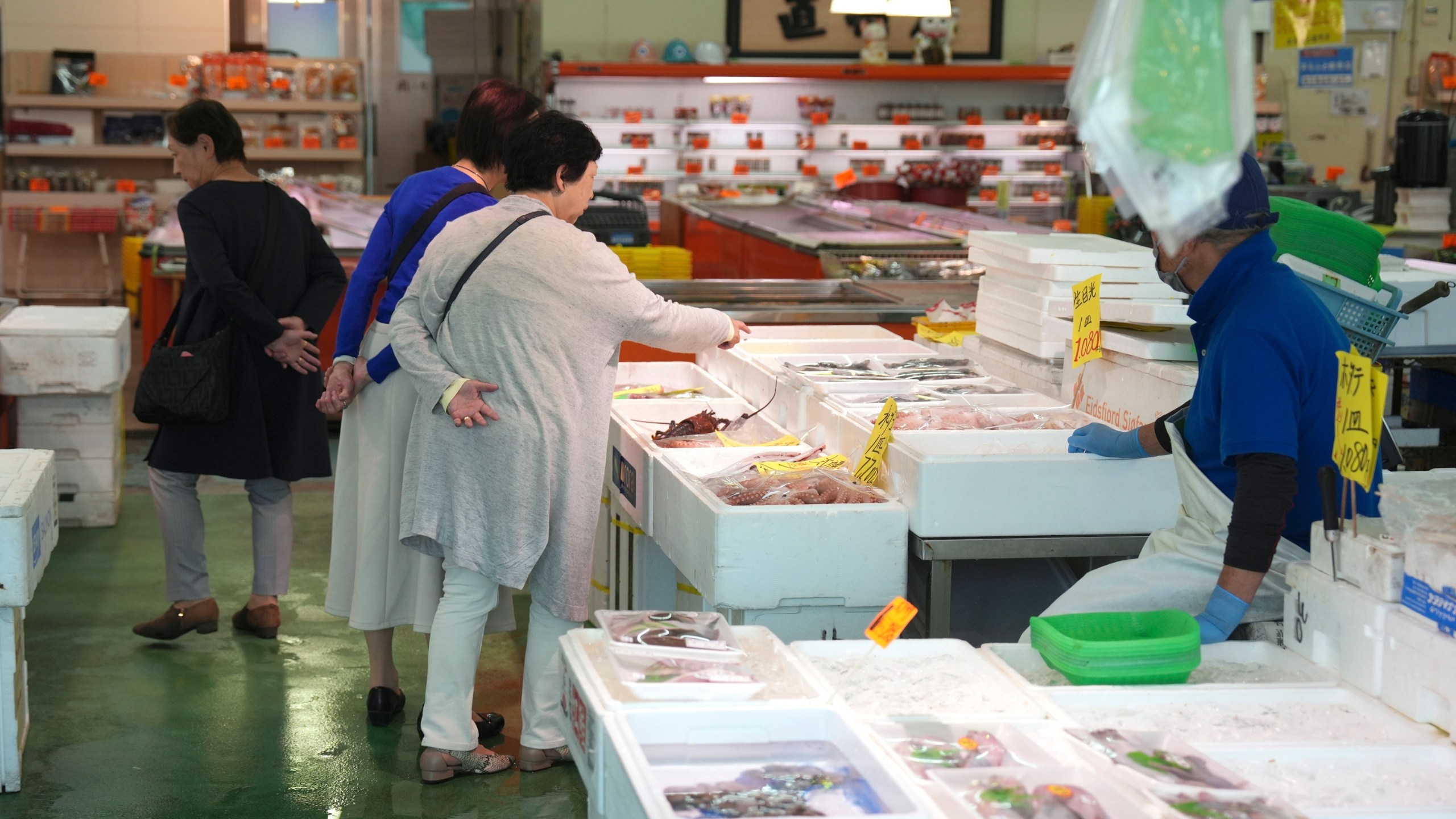 FILE - Visitors check seafood sold at the seafood market "Lalamew" near the Onahama fish port in Iwaki City, Fukushima Prefecture, on Oct. 19, 2023 in Iwaki, northeastern Japan. (AP Photo/Eugene Hoshiko, File)