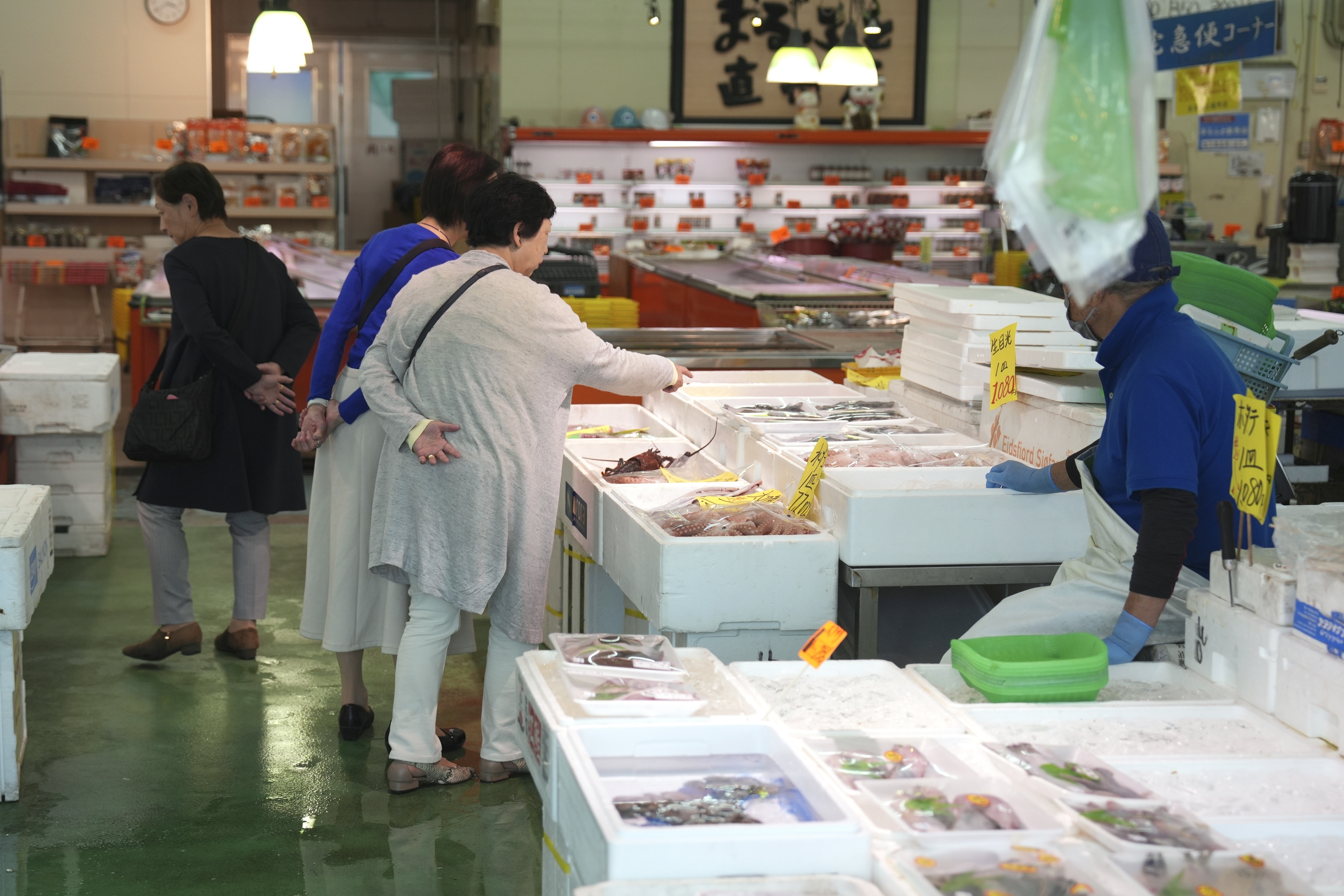 FILE - Visitors check seafood sold at the seafood market "Lalamew" near the Onahama fish port in Iwaki City, Fukushima Prefecture, on Oct. 19, 2023 in Iwaki, northeastern Japan. (AP Photo/Eugene Hoshiko, File)