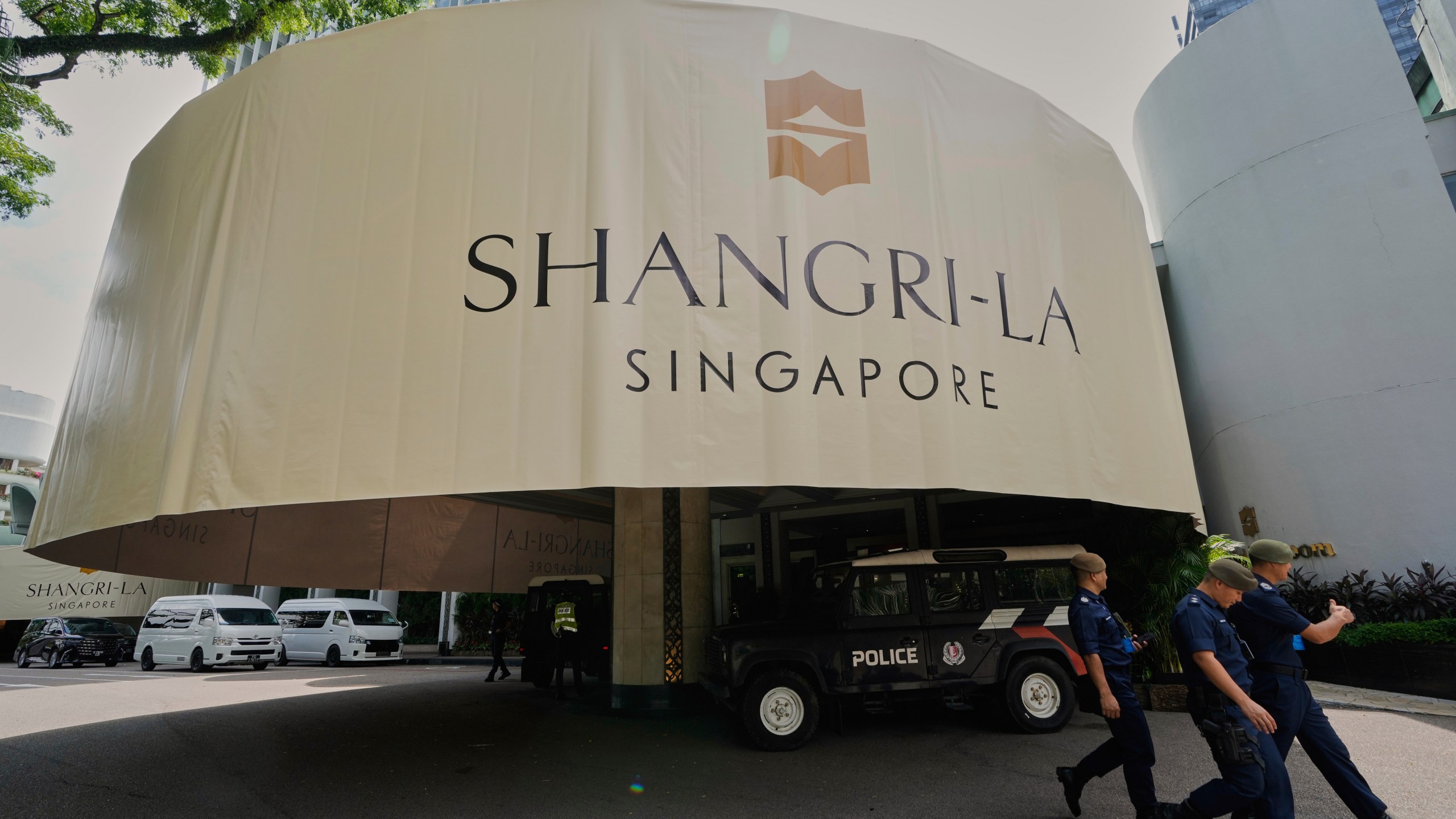 Police officials walk past the venue during the Shangri-La Dialogue summit in Singapore, Friday, May 30, 2025. (AP Photo/Anupam Nath)