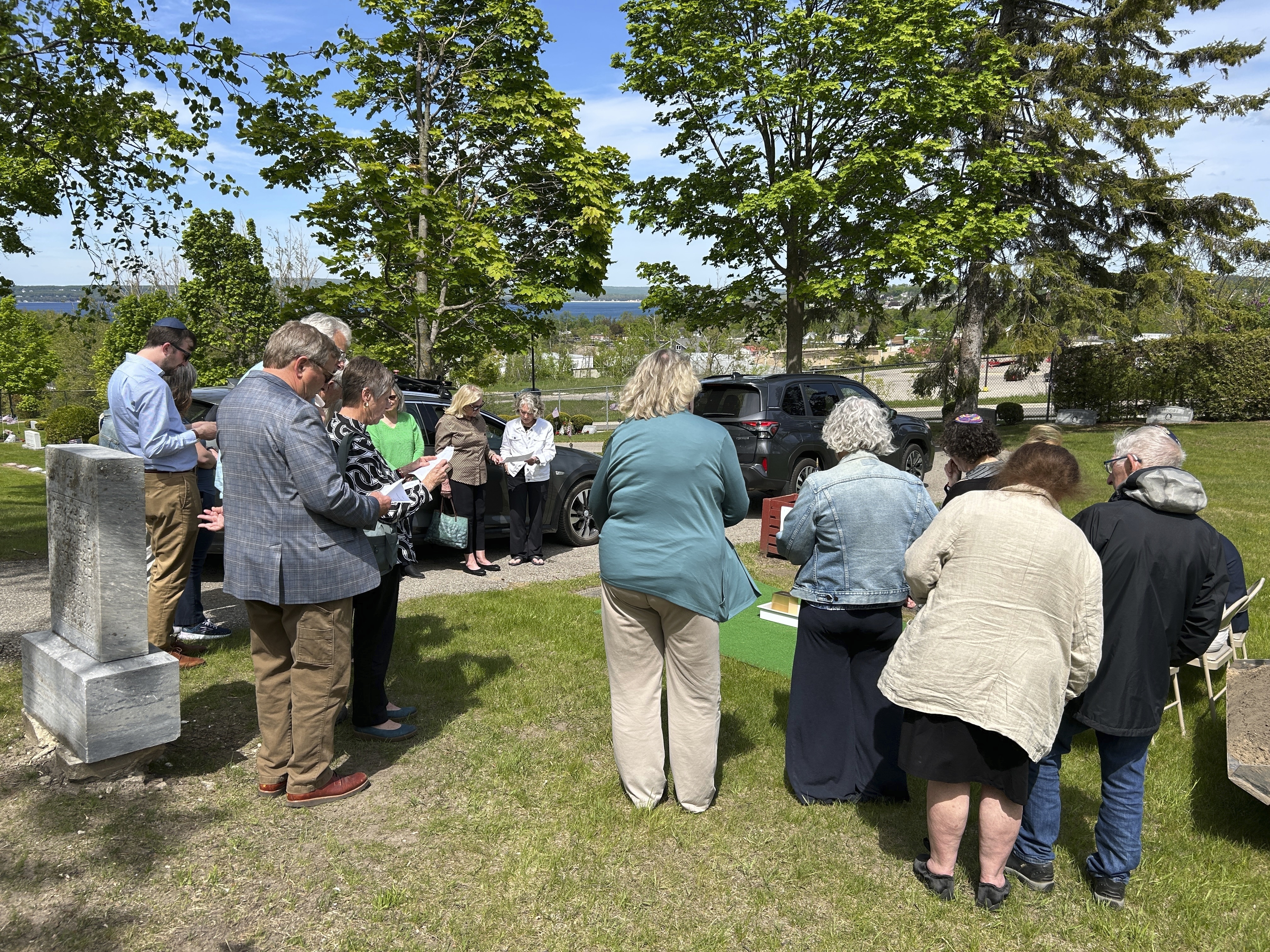 People gather at Greenwood Cemetery for the burial of Larry Rubin, former executive secretary of the Mackinac Bridge Authority, in Petoskey, Mich., Wednesday May 28, 2025. (Daniel Zivian via AP)