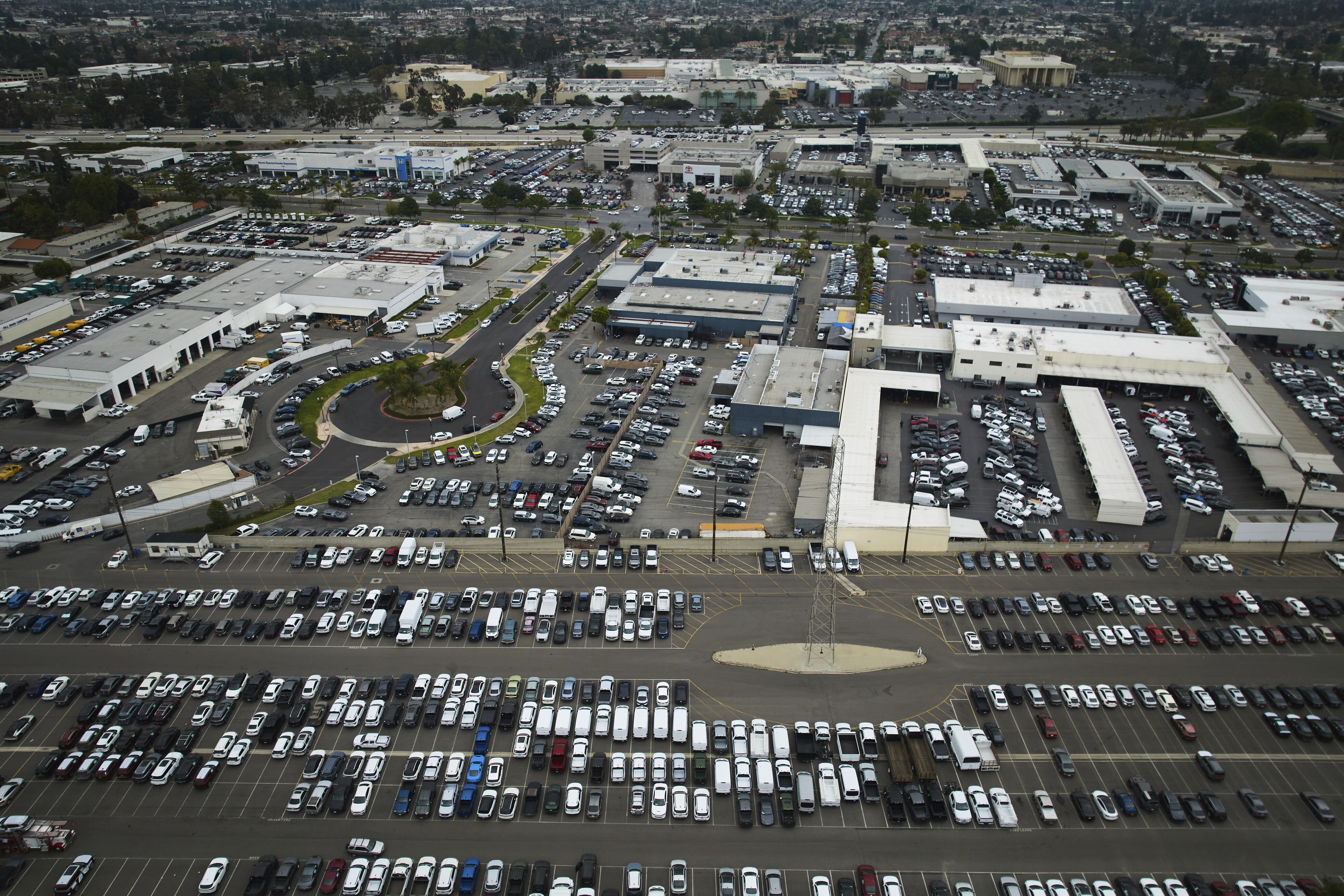 An aerial view shows auto dealerships in Cerritos, Calif., Thursday, March 27, 2025. (AP Photo/Jae C. Hong)