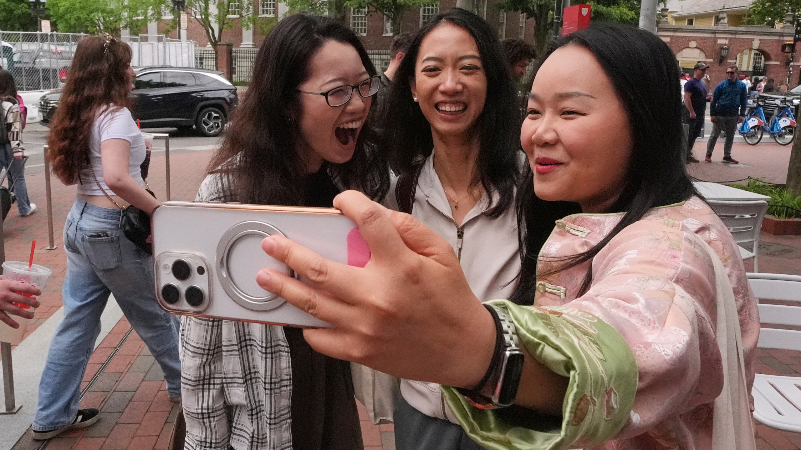 Yurong "Luanna" Jiang, center, who delivered a speech at her Harvard University commencement, takes a selfie with her college friends Cynthia Luo, right, and Helen Ji, Friday, May 30, 2025, in Cambridge, Mass. (AP Photo/Charles Krupa)