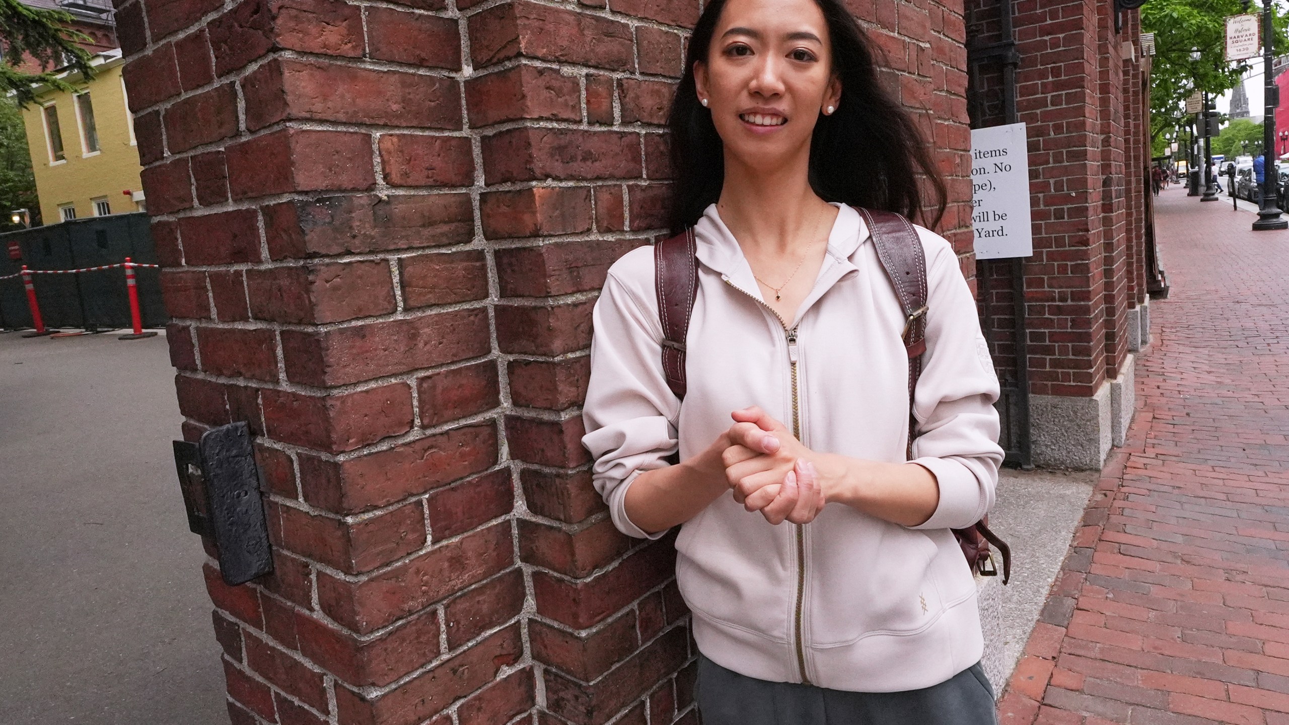 Yurong "Luanna" Jiang, who delivered a speech at her Harvard University commencement, poses at a gate to Harvard Yard, Friday, May 30, 2025, in Cambridge, Mass. (AP Photo/Charles Krupa)