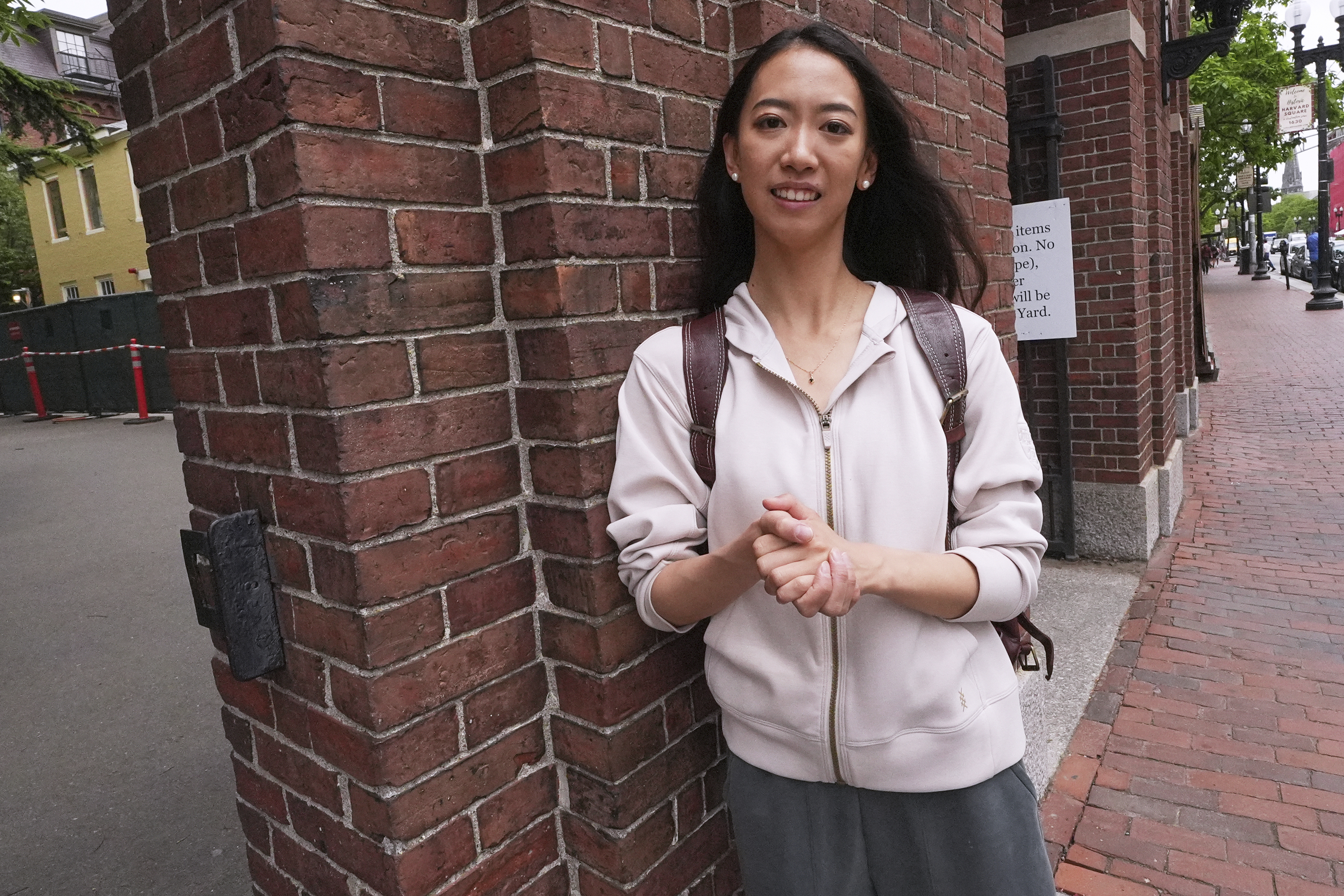 Yurong "Luanna" Jiang, who delivered a speech at her Harvard University commencement, poses at a gate to Harvard Yard, Friday, May 30, 2025, in Cambridge, Mass. (AP Photo/Charles Krupa)