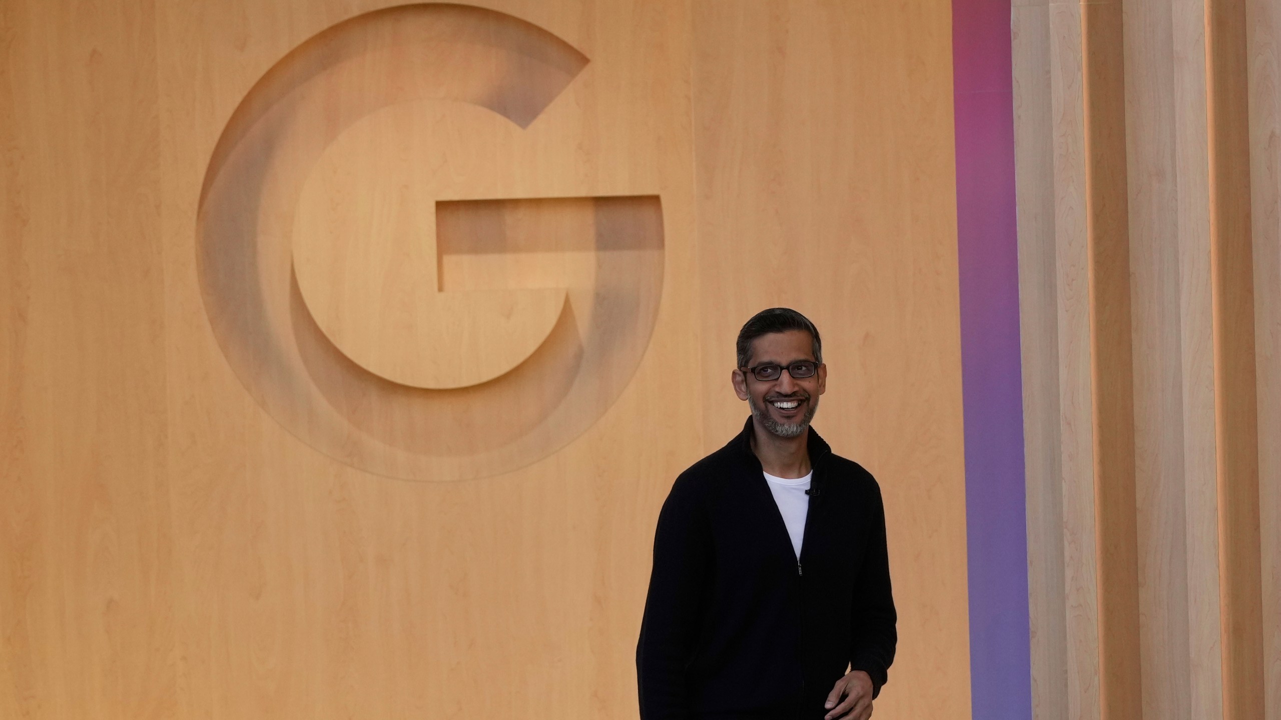Alphabet CEO Sundar Pichai smiles as he walks onto the stage at a Google I/O event in Mountain View, Calif., Tuesday, May 20, 2025. (AP Photo/Jeff Chiu)