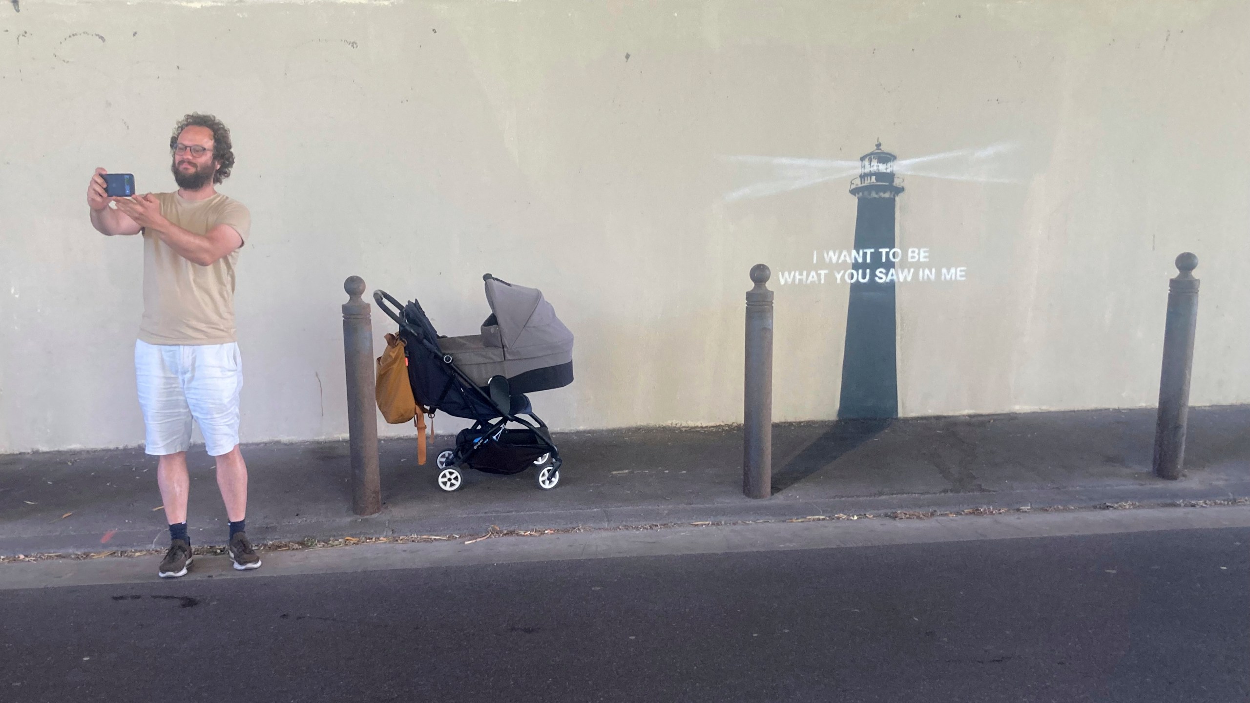 A man makes a selfie by an artwork by street artist Banksy, Friday, May 30, 2025 in Marseille, southern France. (AP Photo/Bishr Eltoni)