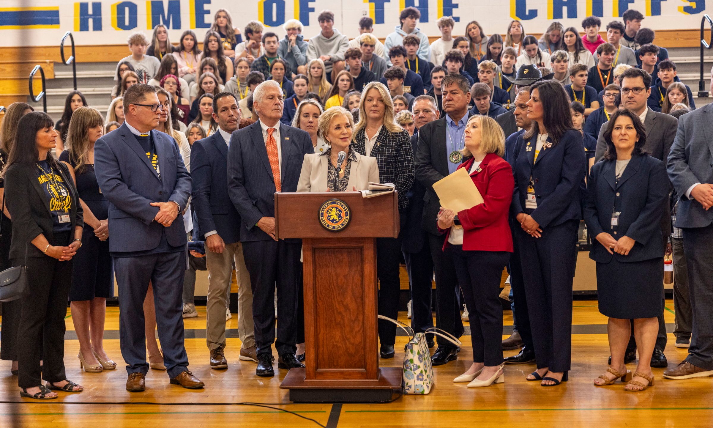 U.S. Secretary of Education Linda McMahon, center, joined by local elected officials speaks during a visit to Massapequa High School, Friday, May 30, 2025, in Massapequa, N.Y. (Alejandra Villa Loarca/Newsday via AP)