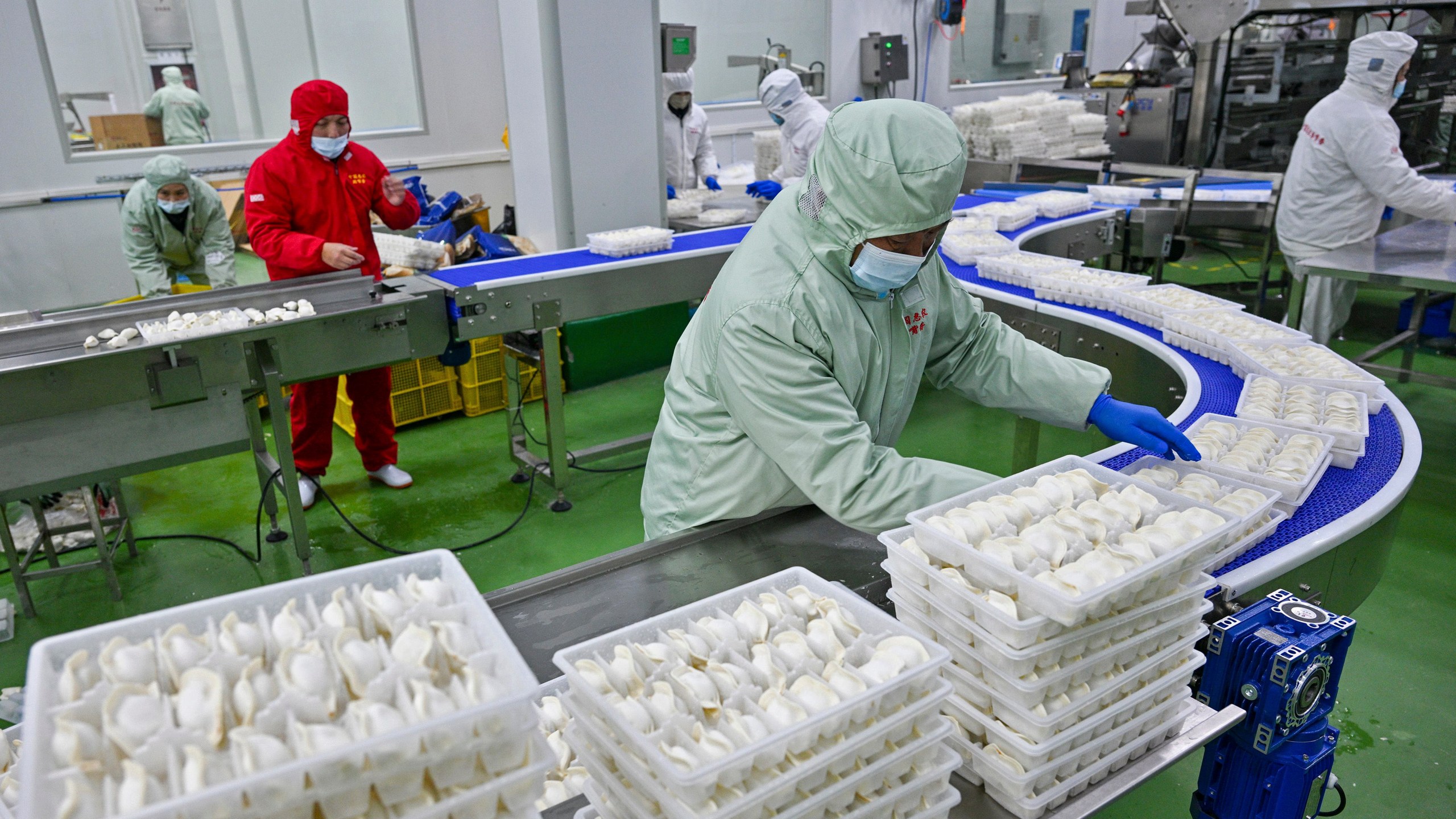 FILE - Workers pack dumplings at a production line at a food factory in Suqian city in east China's Jiangsu province on Jan. 21, 2025. (Chinatopix Via AP, File)
