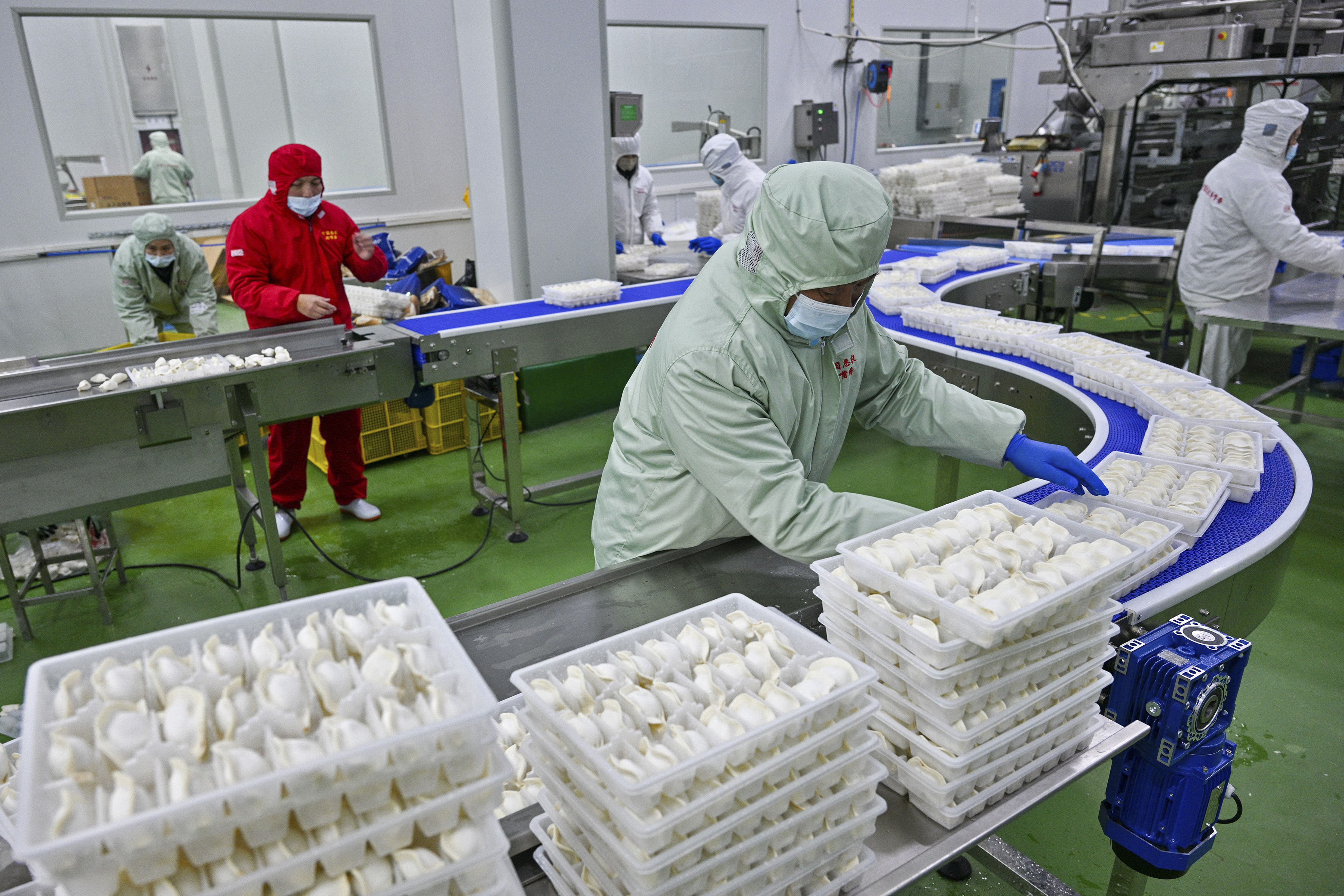 FILE - Workers pack dumplings at a production line at a food factory in Suqian city in east China's Jiangsu province on Jan. 21, 2025. (Chinatopix Via AP, File)
