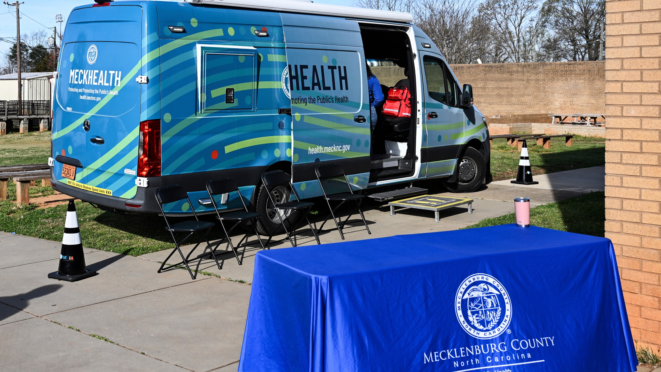 A mobile health unit is parked outside of Independence High School in Charlotte, N.C., on Wednesday, March 19, 2025. (AP Photo/Matt Kelley)