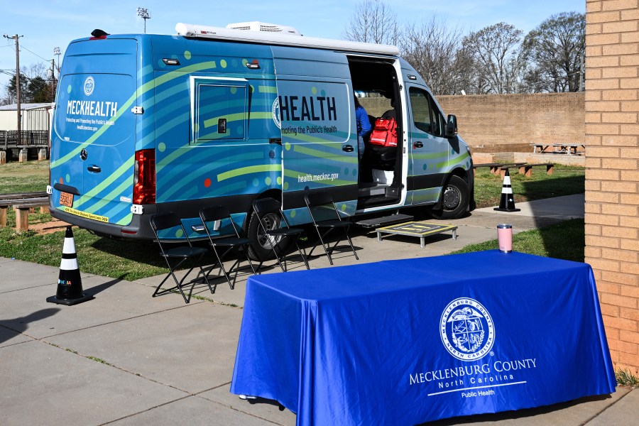 A mobile health unit is parked outside of Independence High School in Charlotte, N.C., on Wednesday, March 19, 2025. (AP Photo/Matt Kelley)
