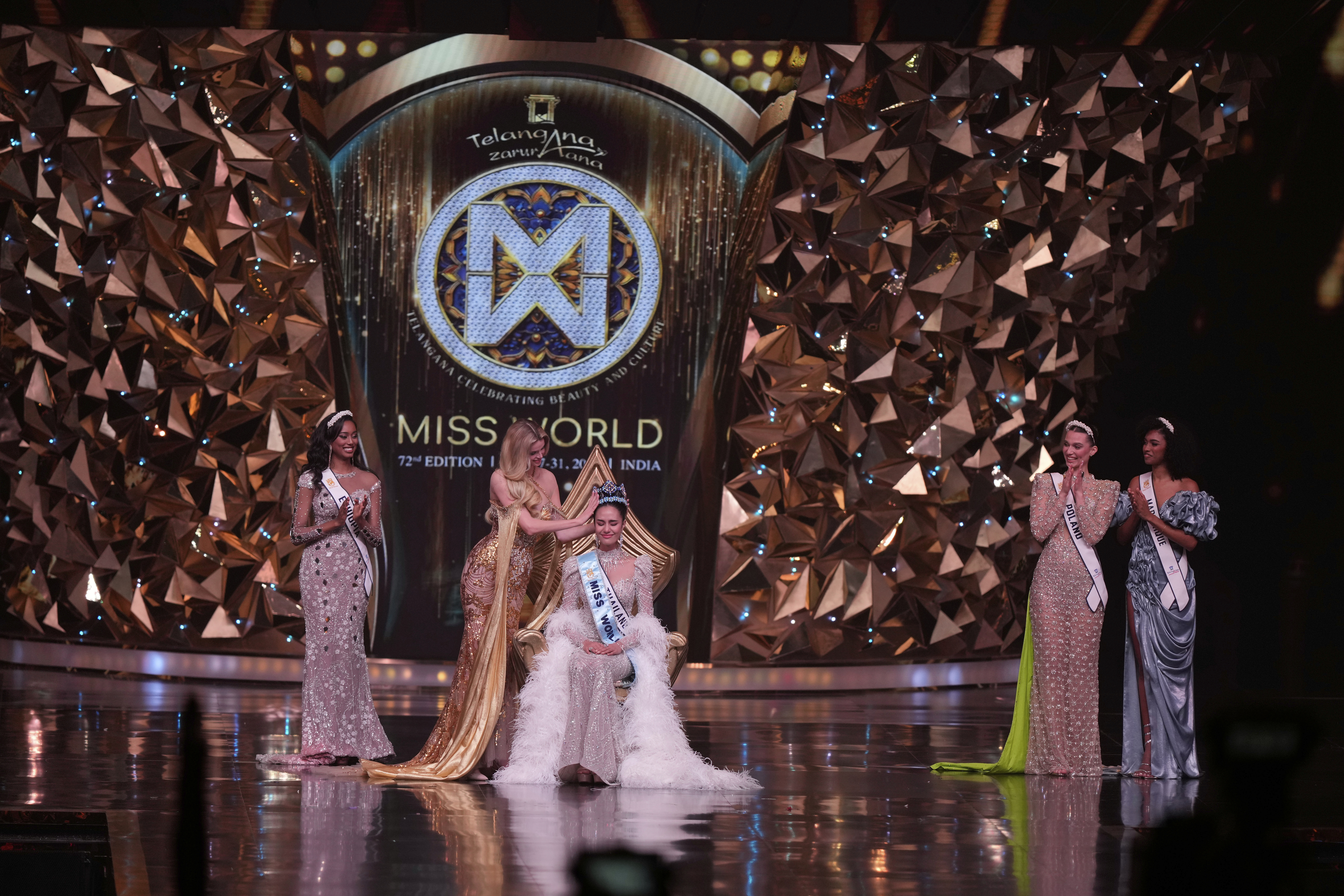 Krystyna Pyszkova of Czech Republic, crowns her successor Opal Suchata of Thailand after she who won the 72nd Miss World pageant in Hyderabad, India, Saturday, May 31, 2025. (AP Photo/Mahesh Kumar A.)