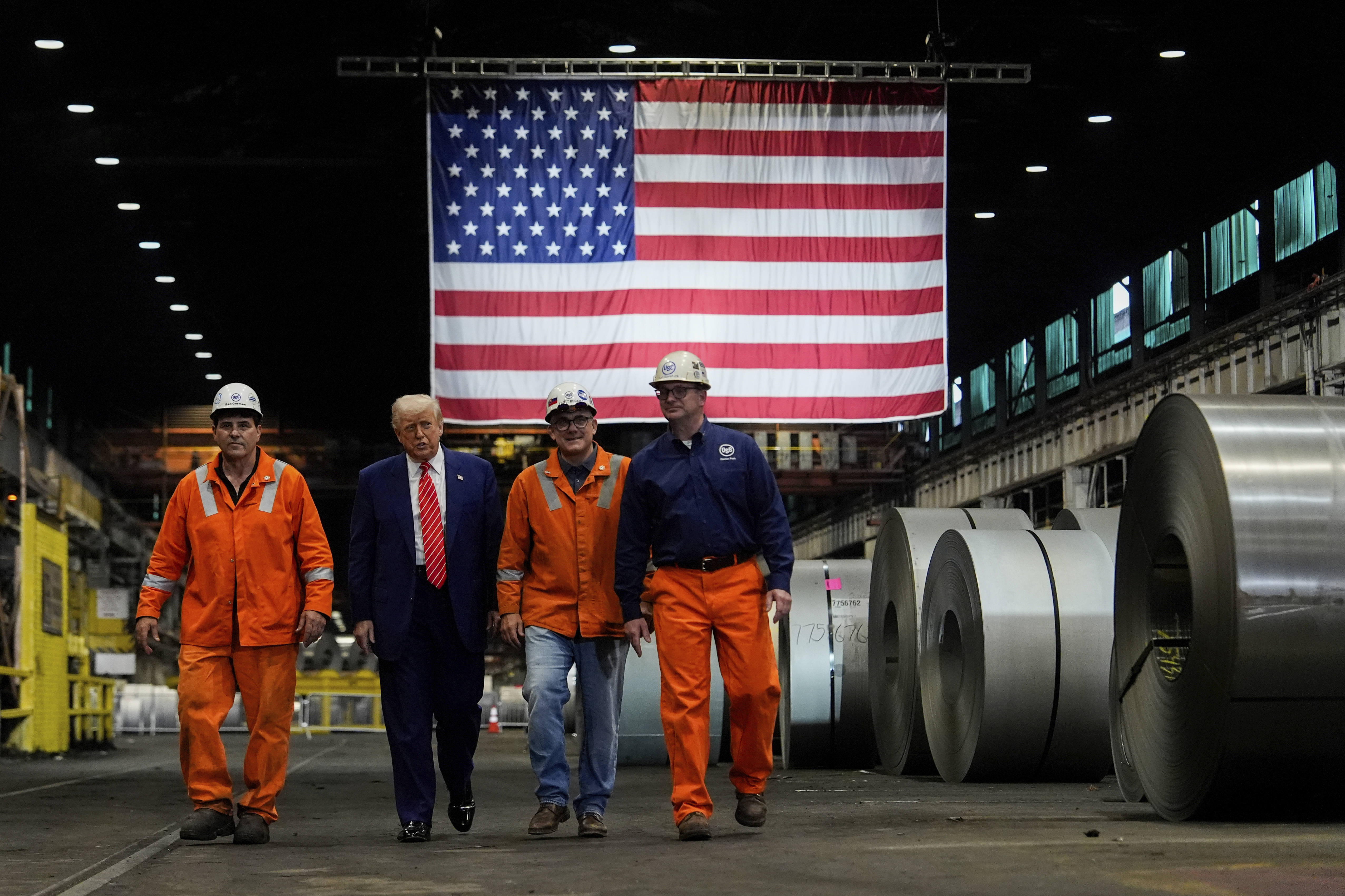 President Donald Trump walks with workers as he tours U.S. Steel Corporation's Mon Valley Works-Irvin plant, Friday, May 30, 2025, in West Mifflin, Pa. (AP Photo/Julia Demaree Nikhinson)