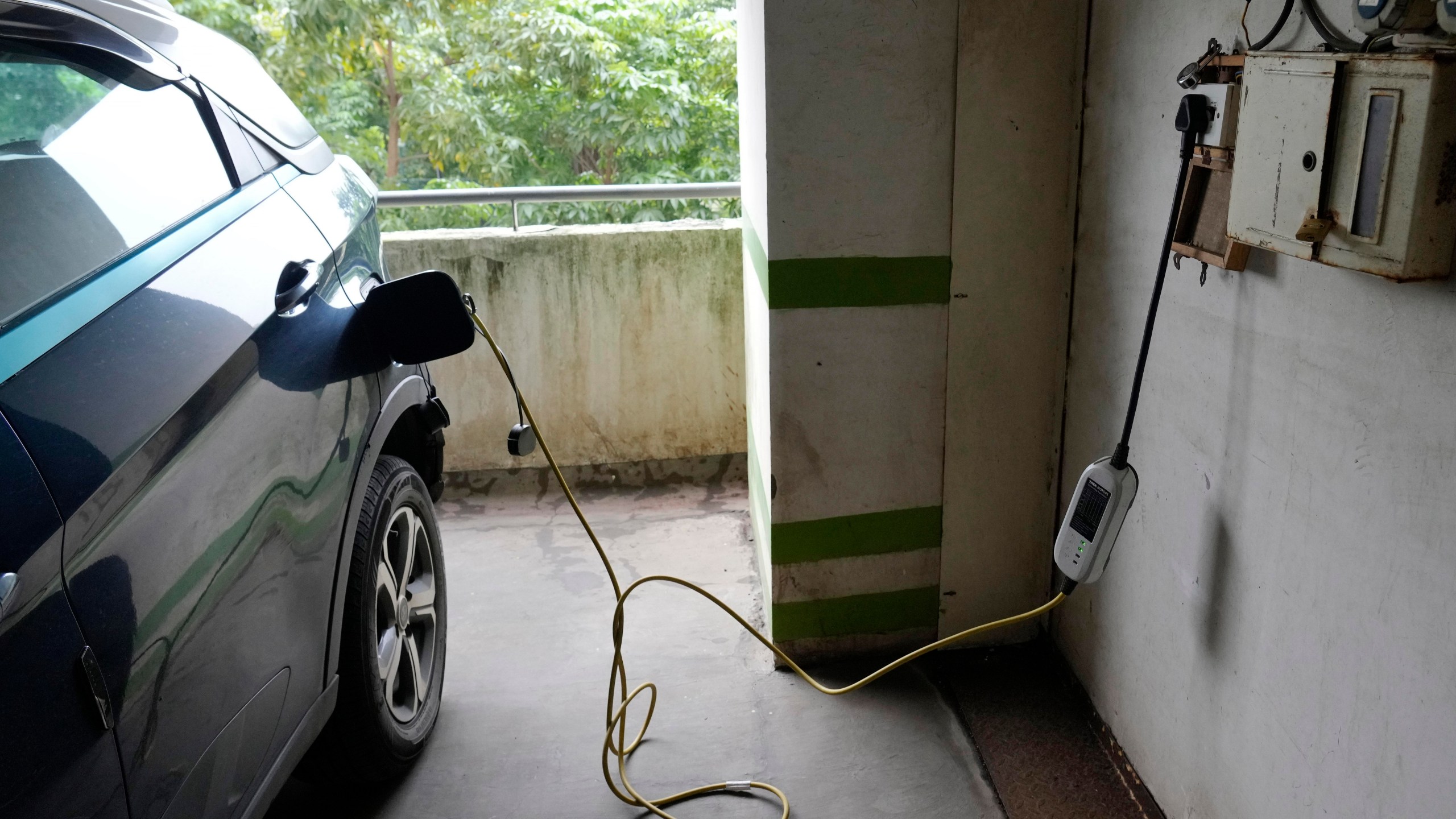 FILE - A car gets charged at an electric vehicle charging station at a residential building parking area in Mumbai, India, July 23, 2024. (AP Photo/Rajanish Kakade, File)