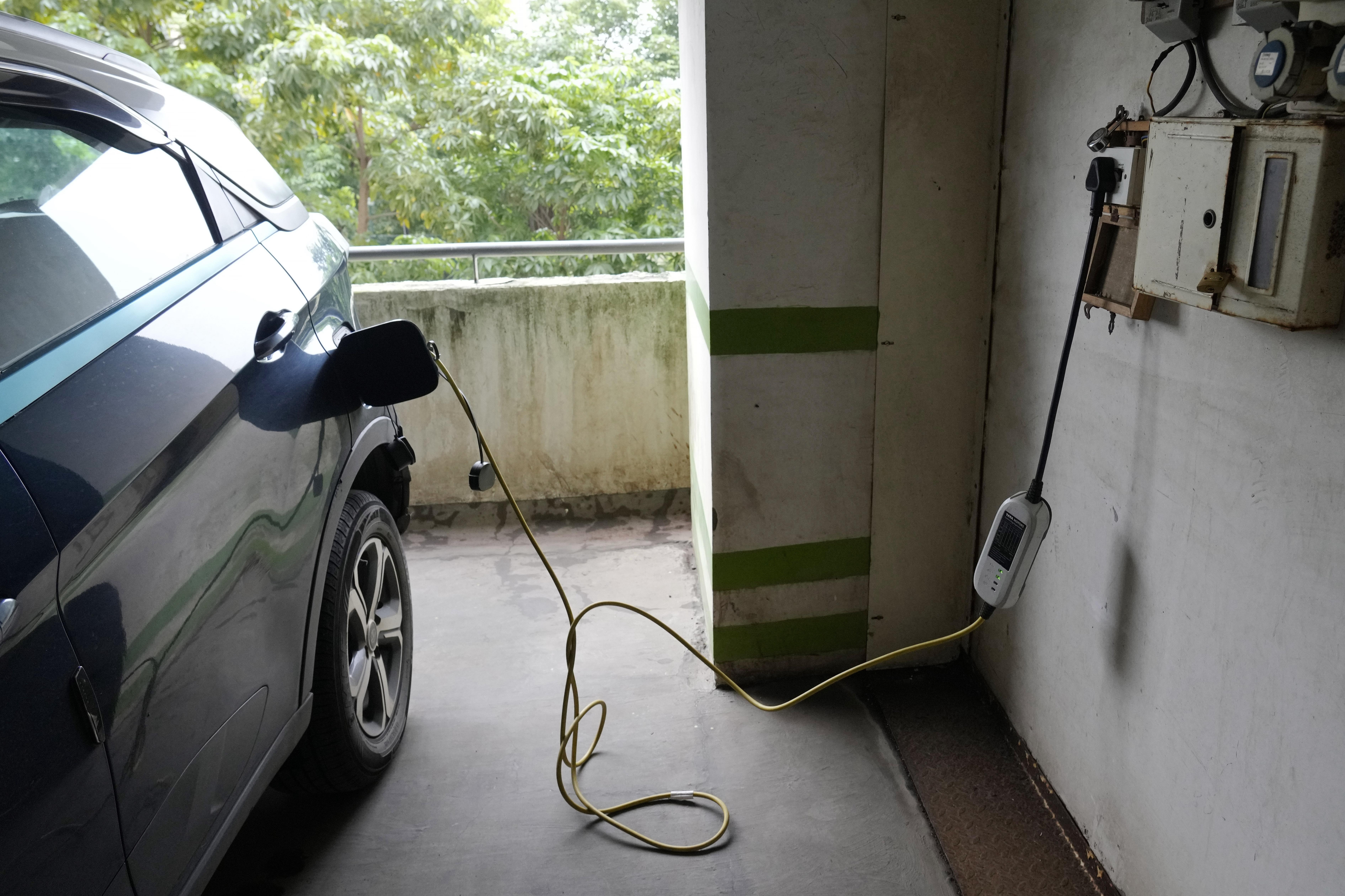 FILE - A car gets charged at an electric vehicle charging station at a residential building parking area in Mumbai, India, July 23, 2024. (AP Photo/Rajanish Kakade, File)